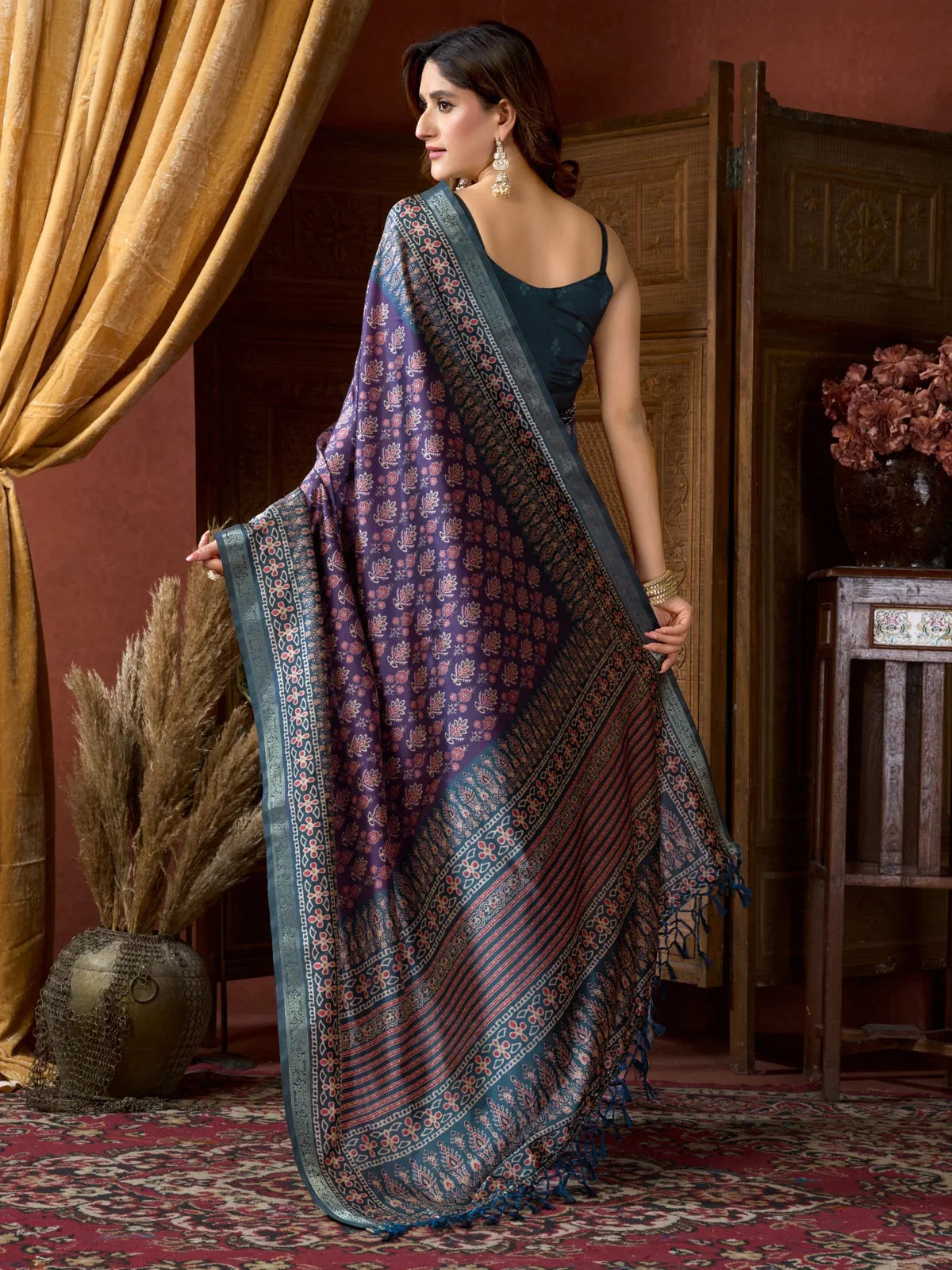Tarani purple saree back pose showing detailed drape and tassel edge