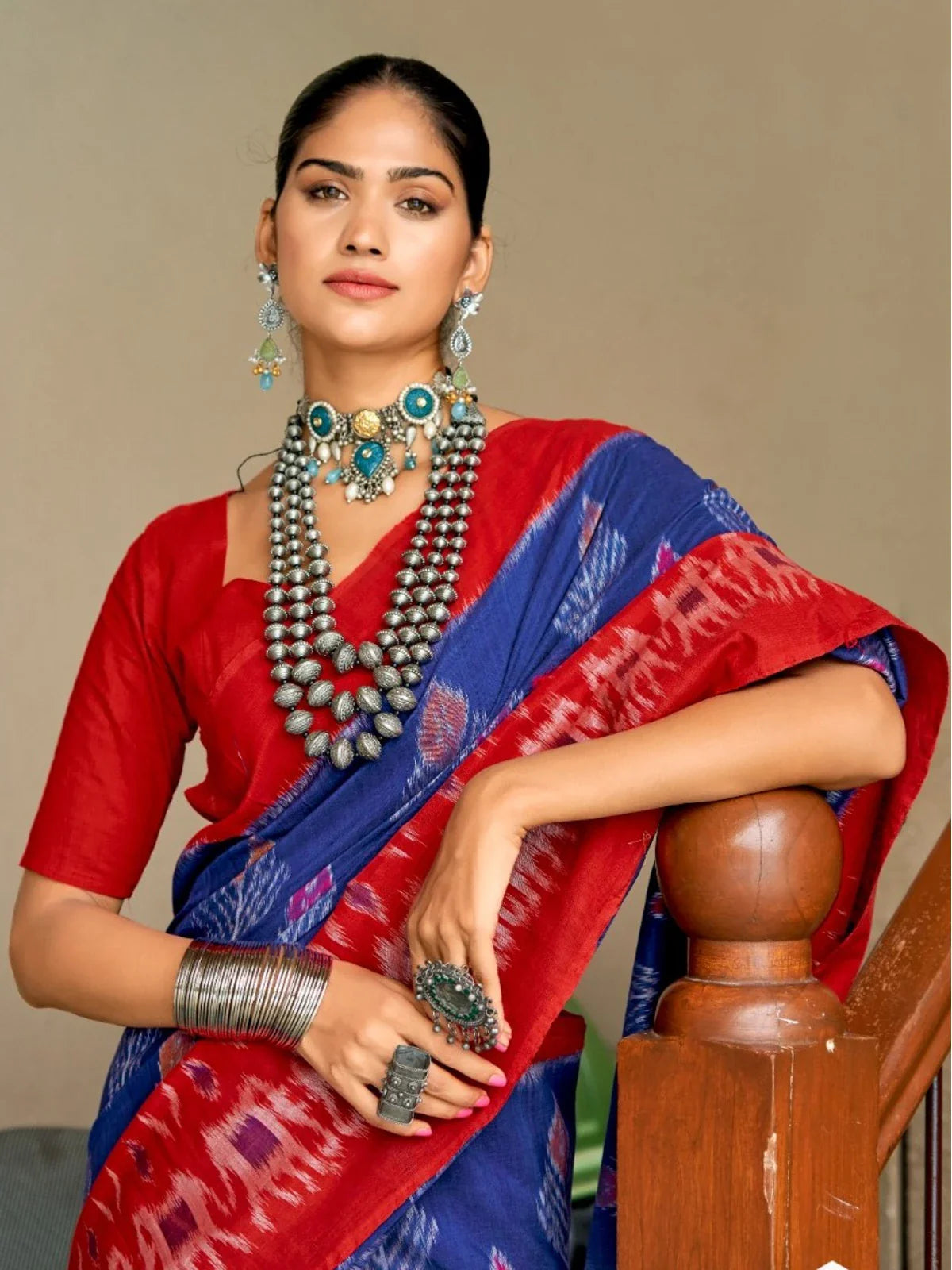 Tarani blue cotton blend Ikat saree upper body closeup showing blouse and jewelry