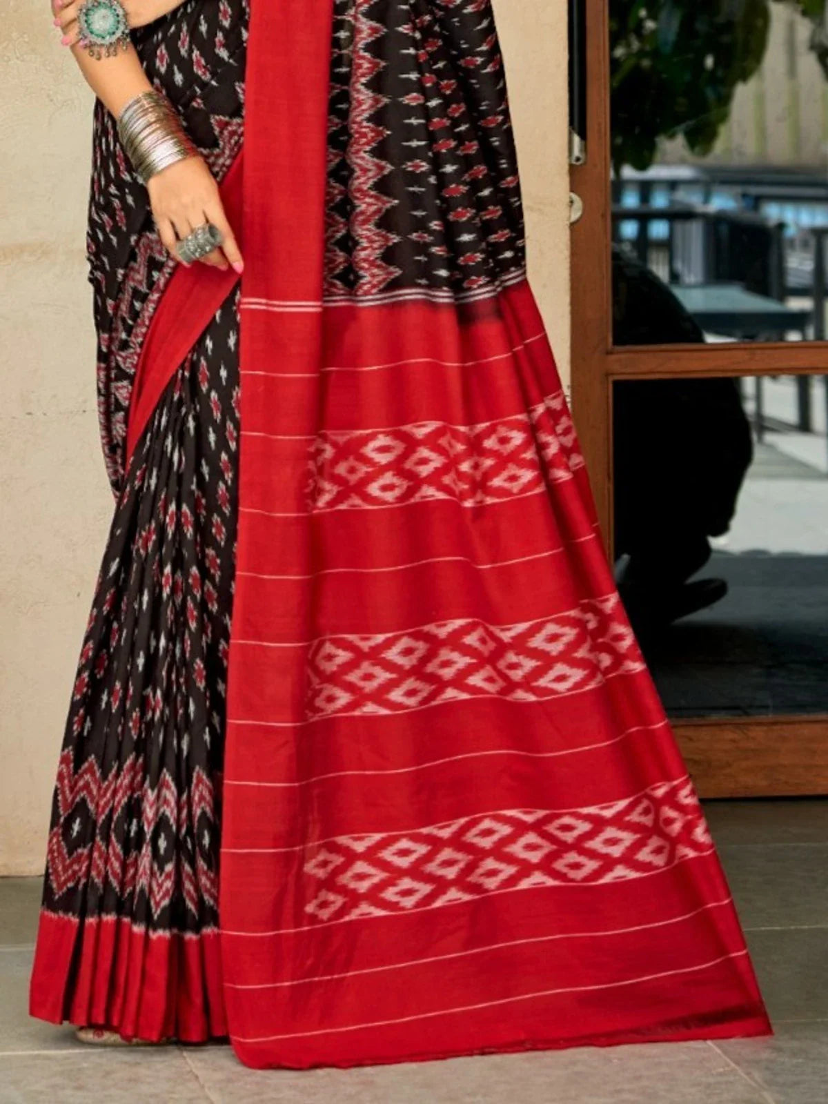 Tarani red Ikat saree pallu view showing woven detailing and border design