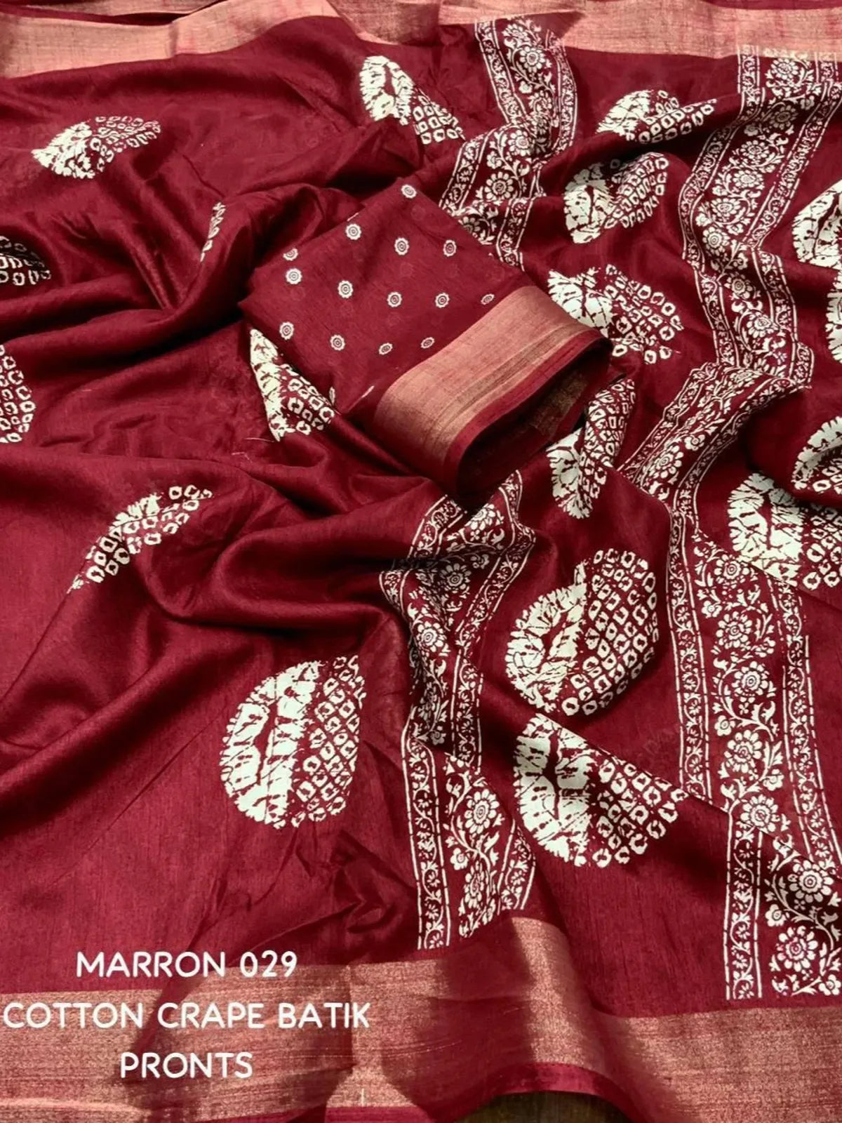 Tarani maroon cotton crape saree closeup view displaying rich batik patterns and border detailing