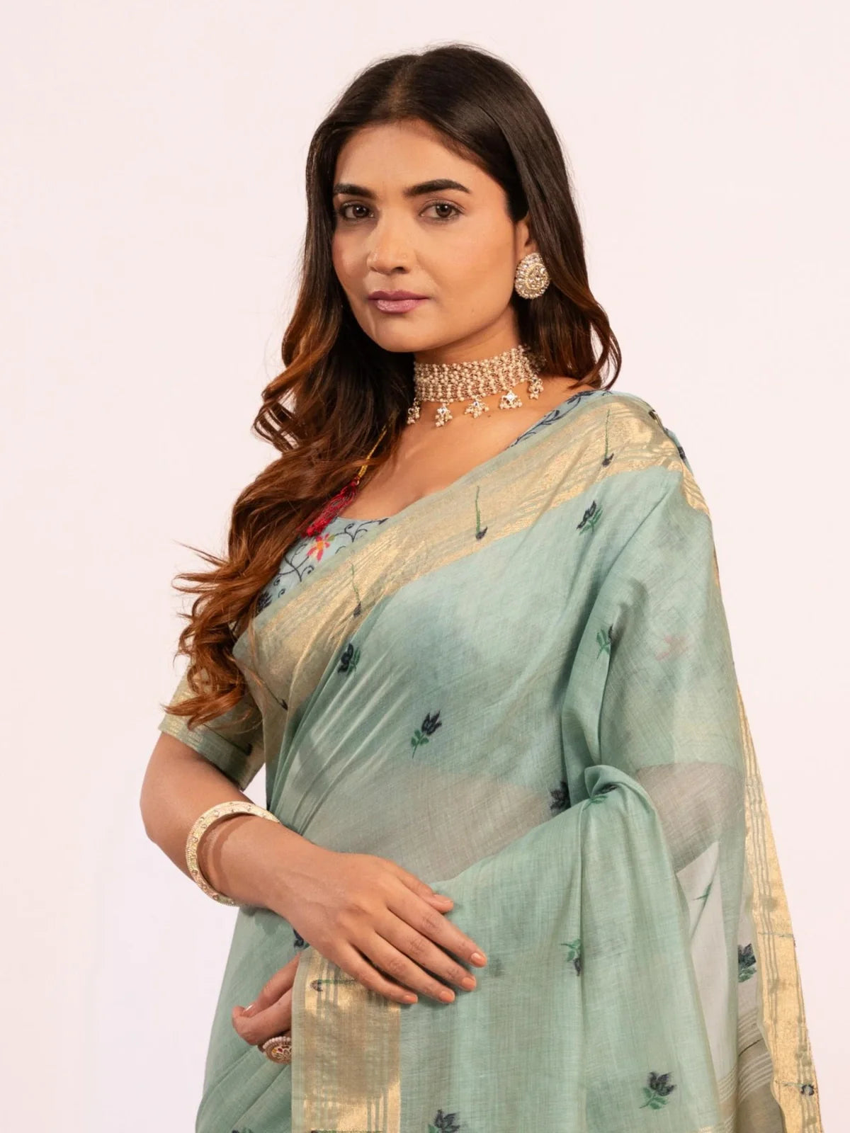 Tarani upper body view of green cotton paithani saree with soft woven detailing and zari border