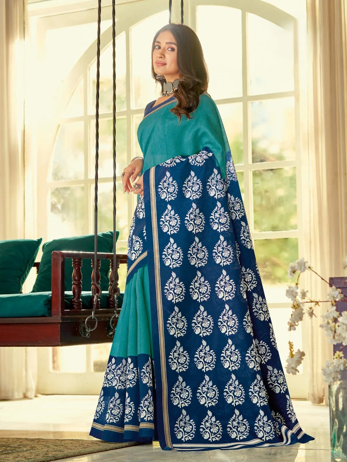 Tarani teal blue cotton silk saree with traditional motifs and attached blouse piece
