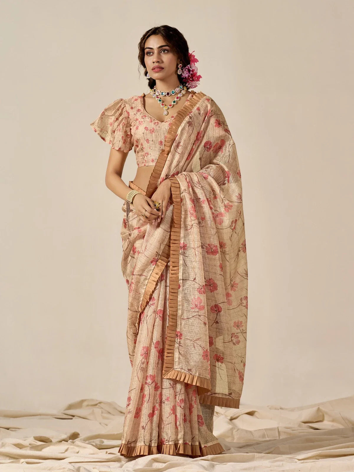 Tarani beige cotton blend saree with floral print and pleated border, perfect for festive and party wear