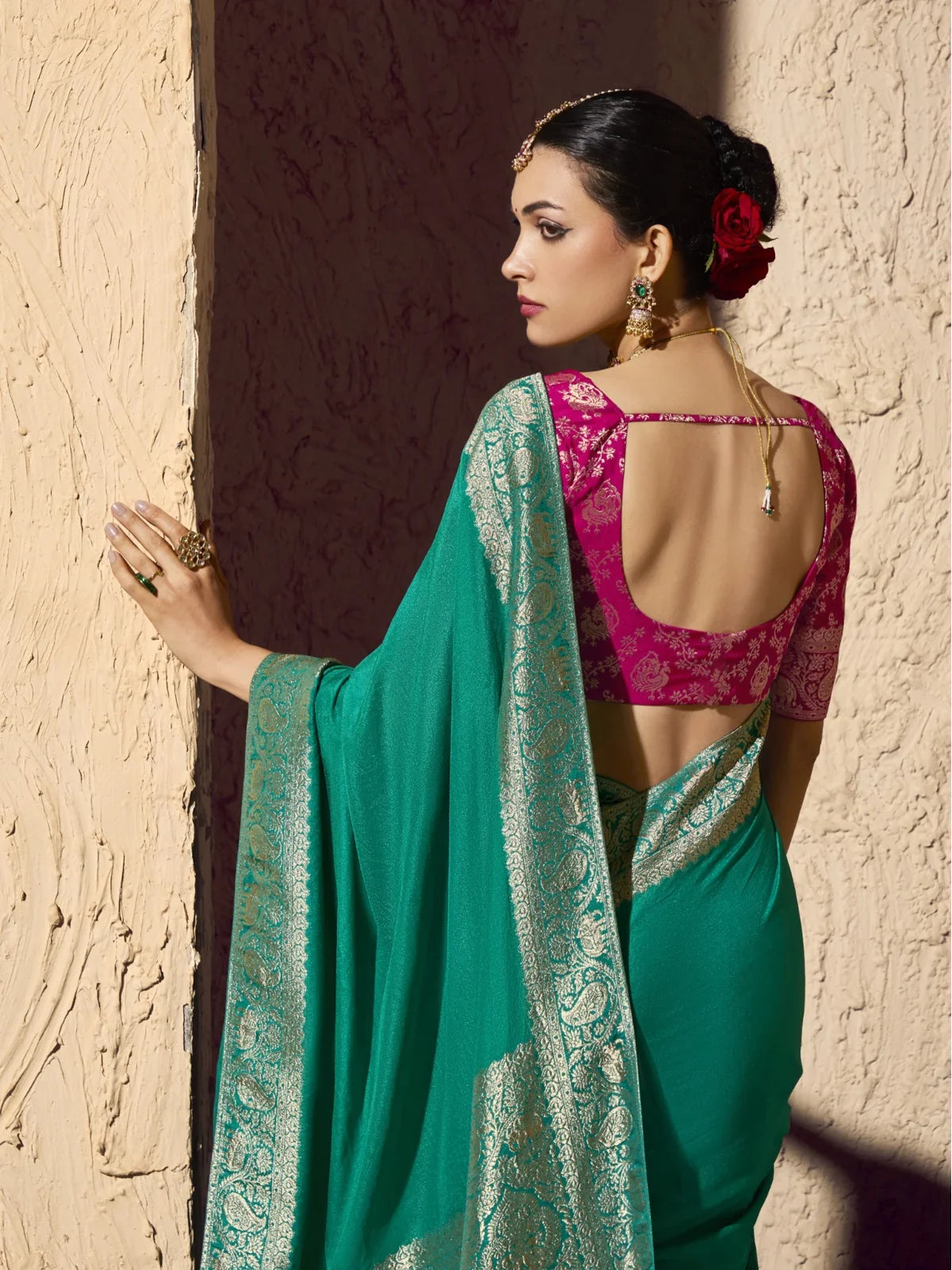 Tarani saree back view showcasing open-back pink blouse and elegant saree drape for festive look
