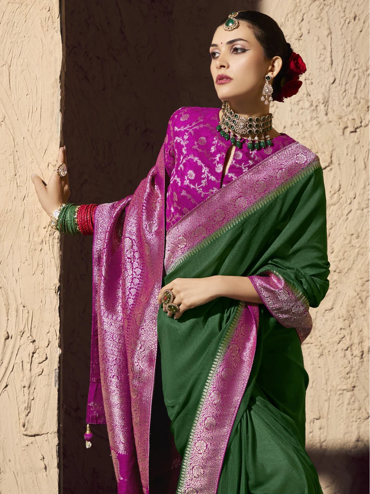Tarani premium green saree upper body closeup showing rich pink blouse and jewellery
