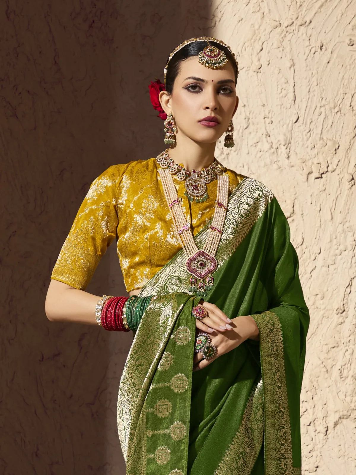 Tarani close view of model wearing green crepe georgette saree with jewellery and blouse