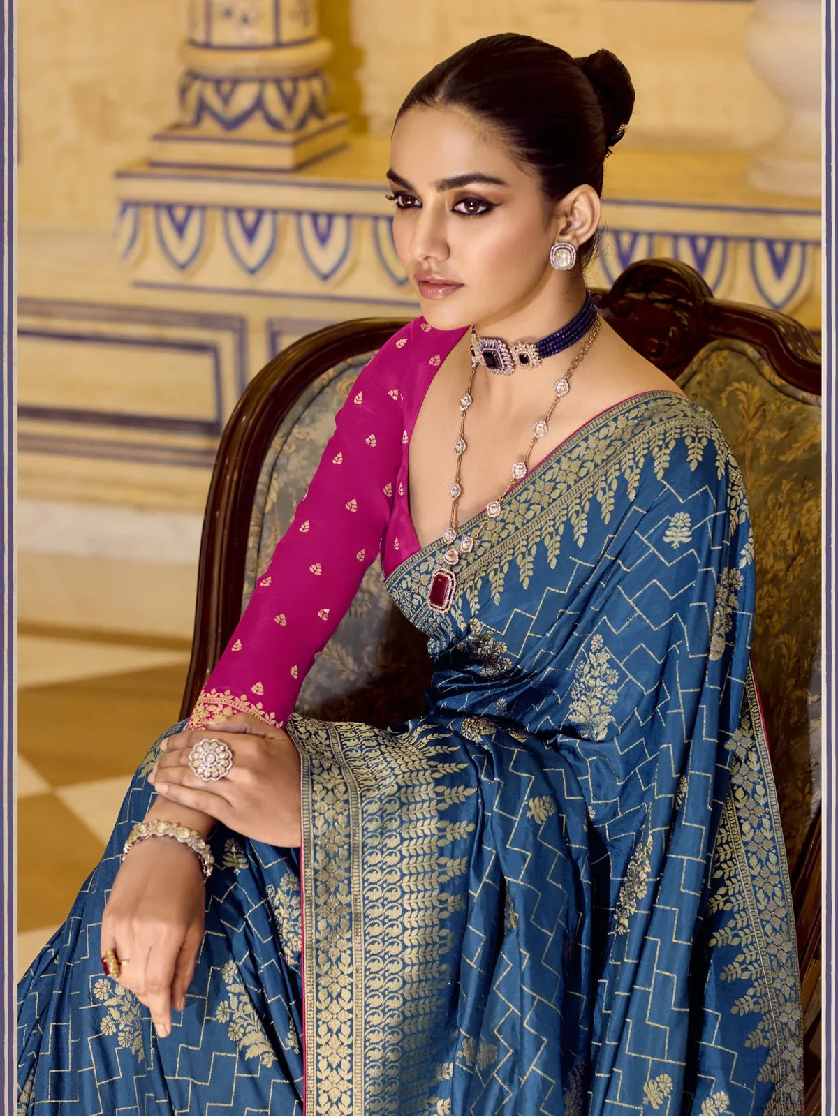 Tarani upper body view of blue crepe silk saree with magenta blouse and golden detailing