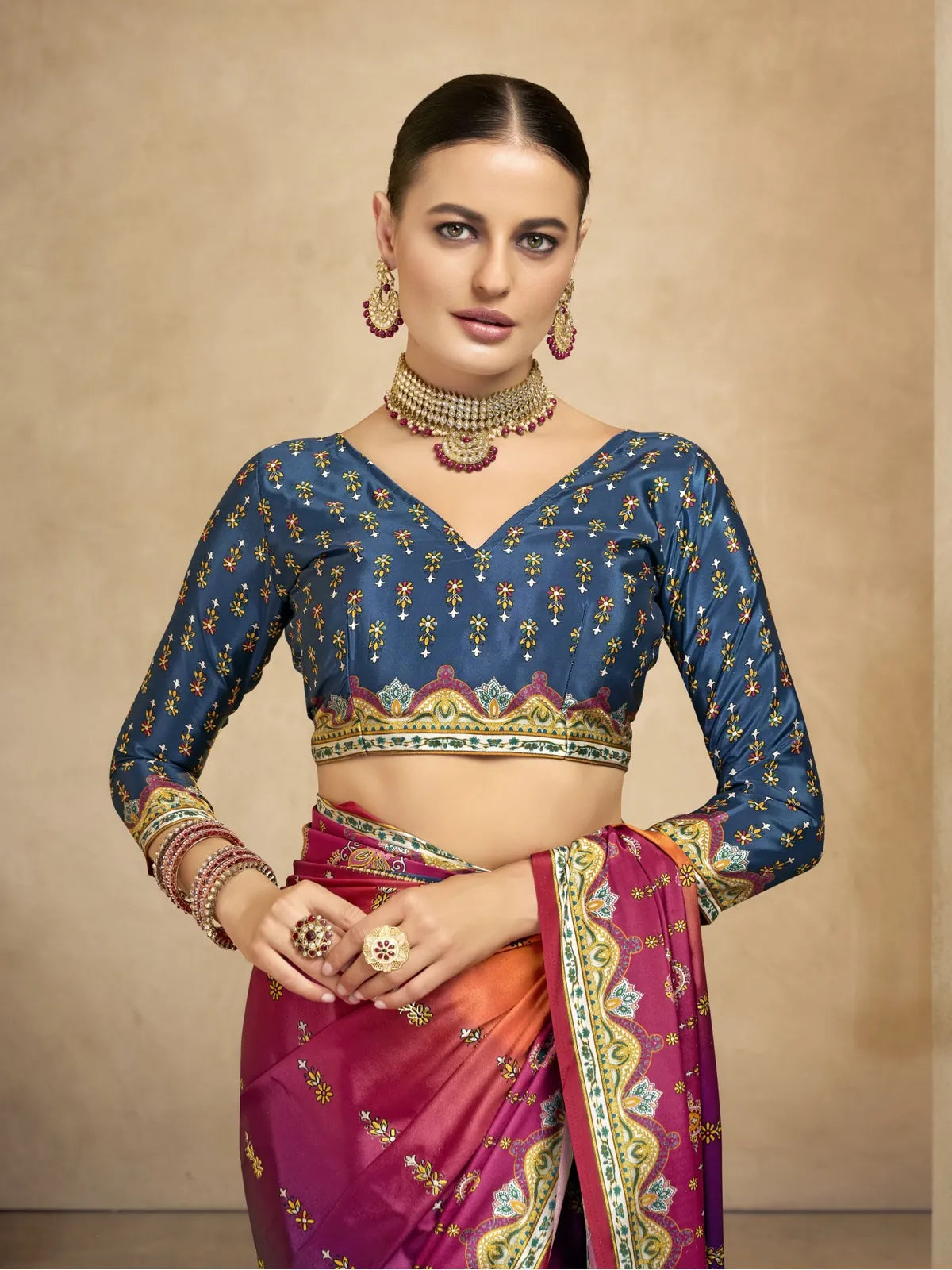 Tarani festive crepe saree in upper body view with deep blue printed blouse and foil accents