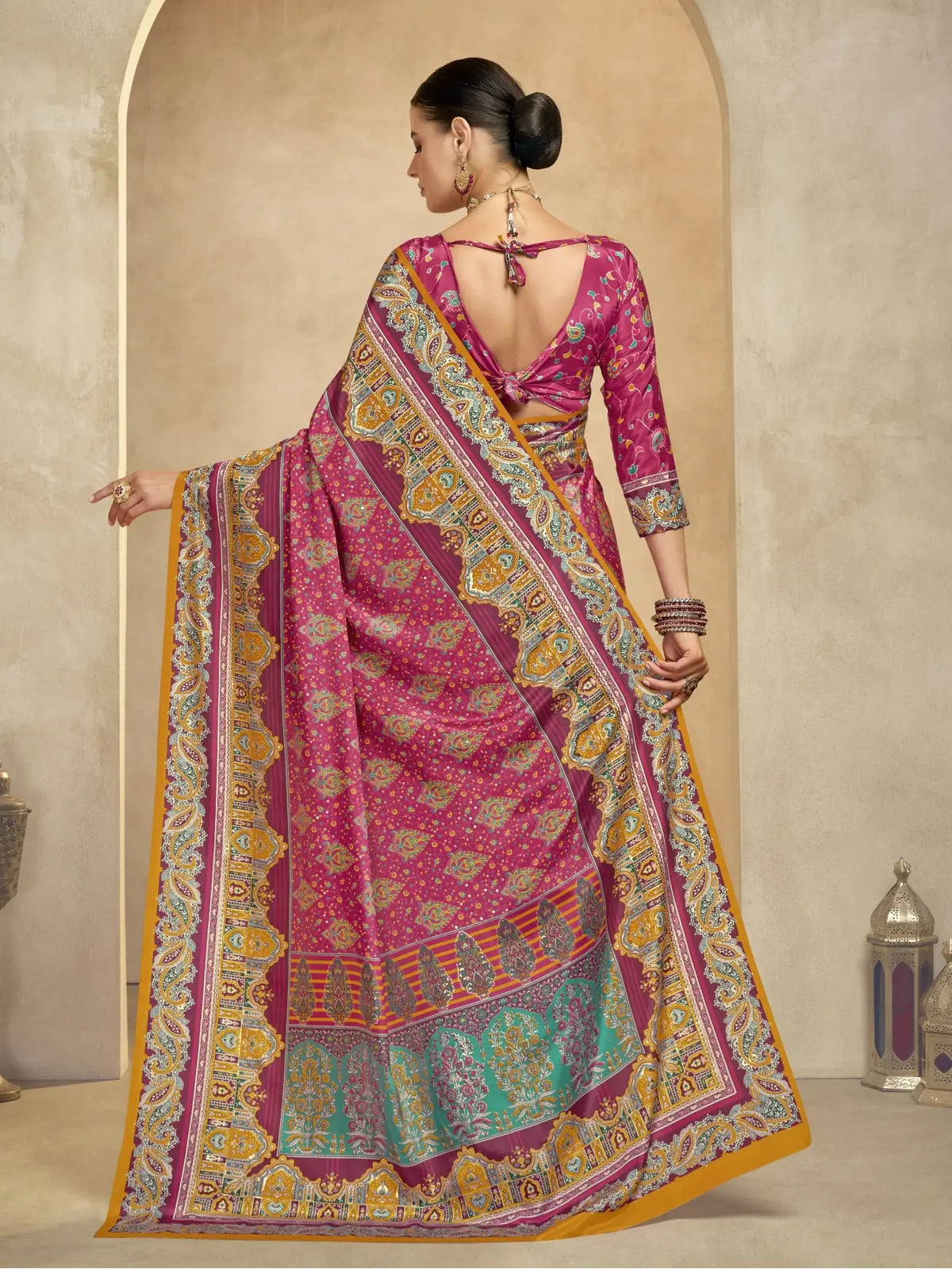 Tarani festive saree back view highlighting pallu drape and blouse style