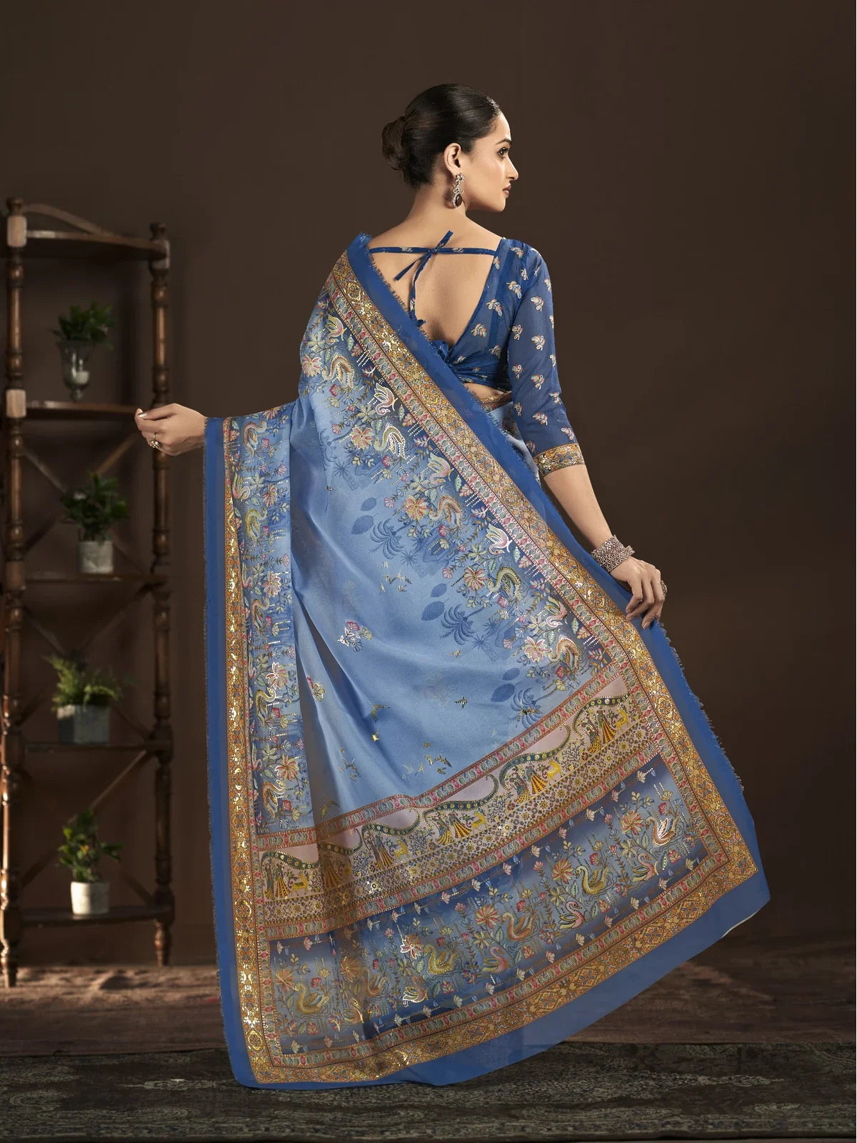 Tarani back pose of premium crepe silk saree in blue with foil work and stylish drape