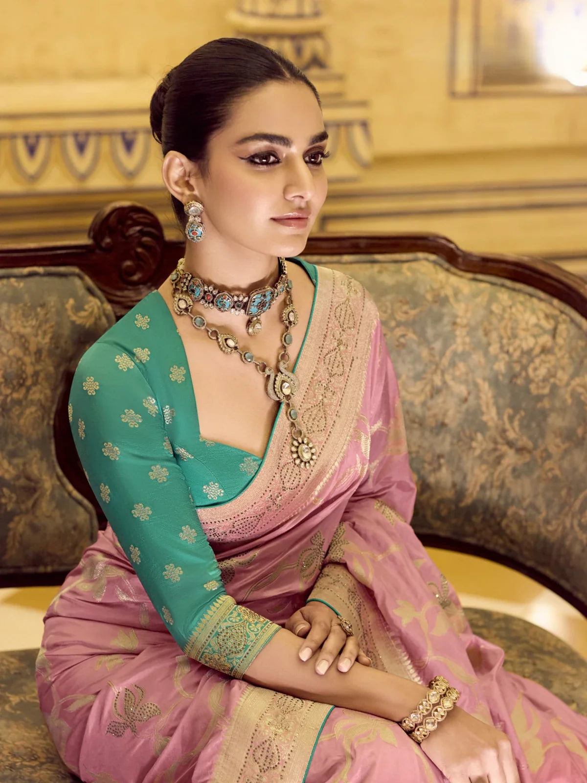 Tarani premium crepe silk saree in pink with elegant green blouse shown in upper body closeup