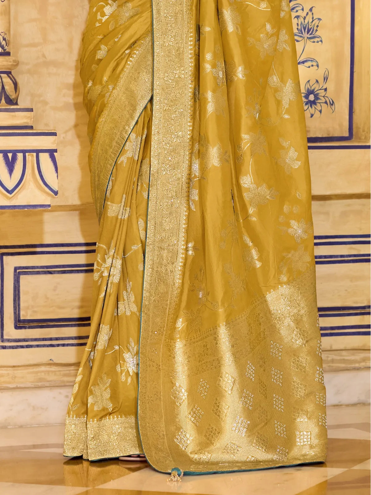 Full view of Tarani mustard yellow crepe silk saree with rich zari work and contrasting green blouse