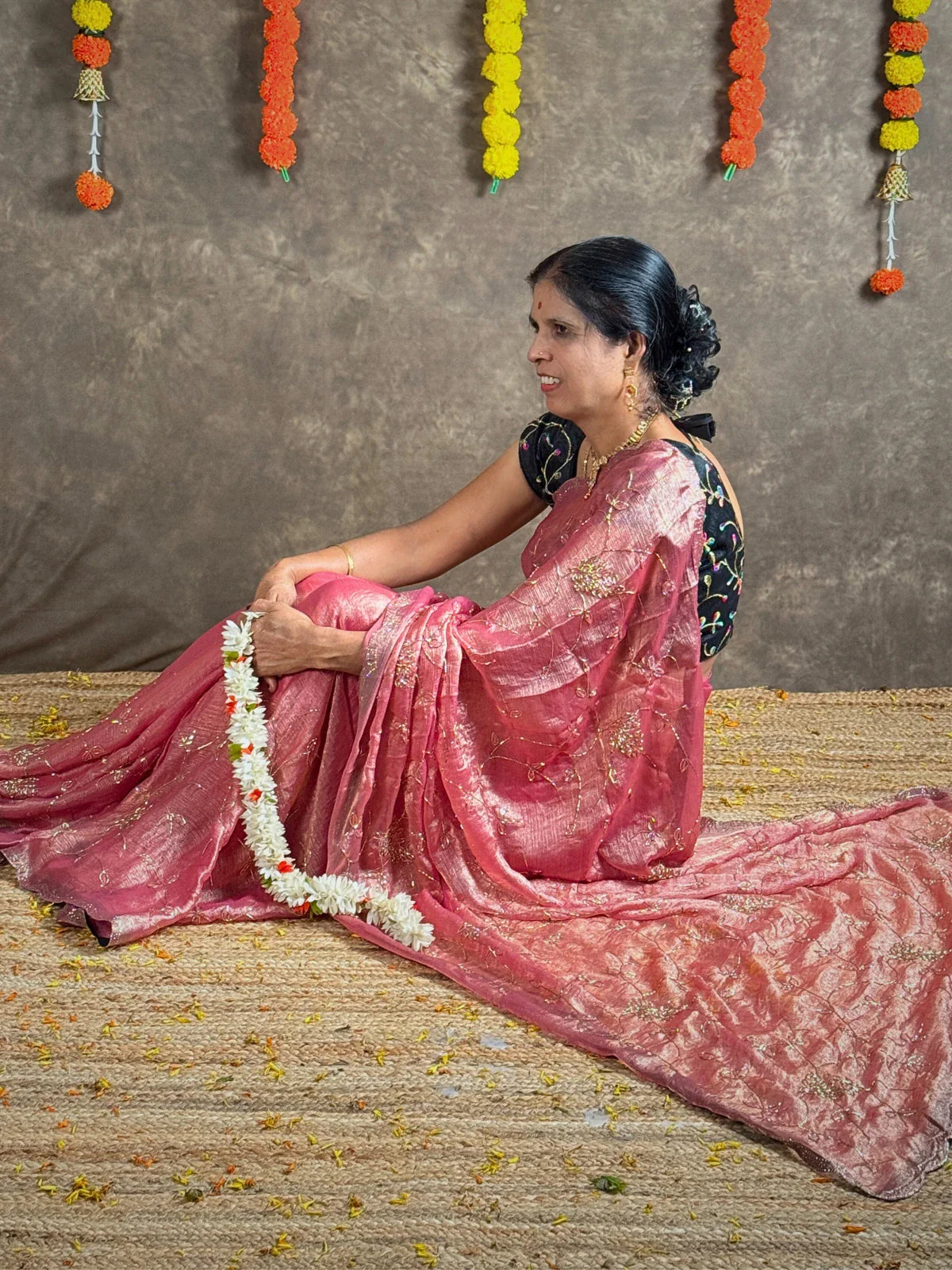 Tarani pink crystal silk saree side pose with graceful festive appeal