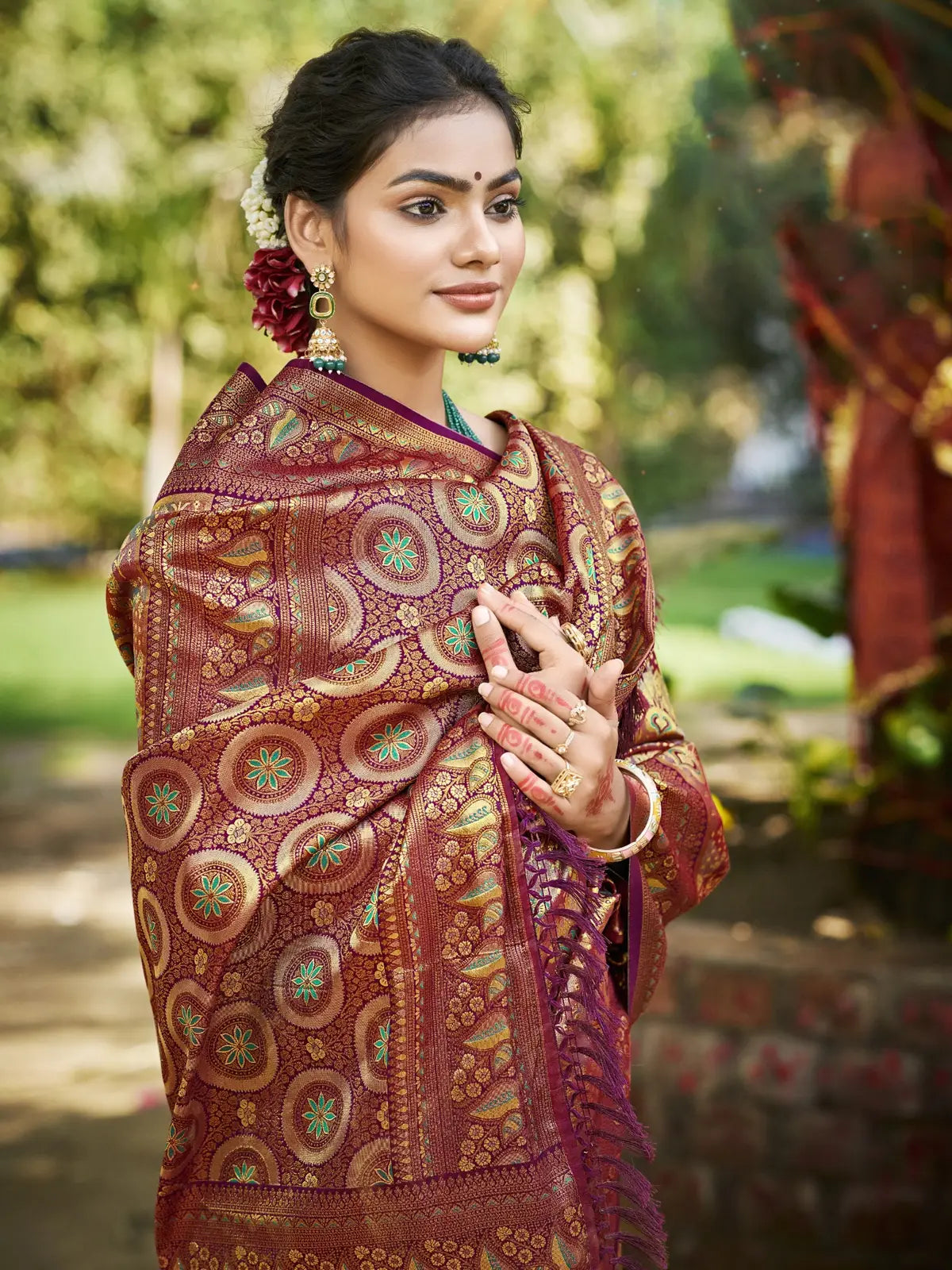 Tarani maroon Dharmavaram saree upper-body closeup highlighting zari design