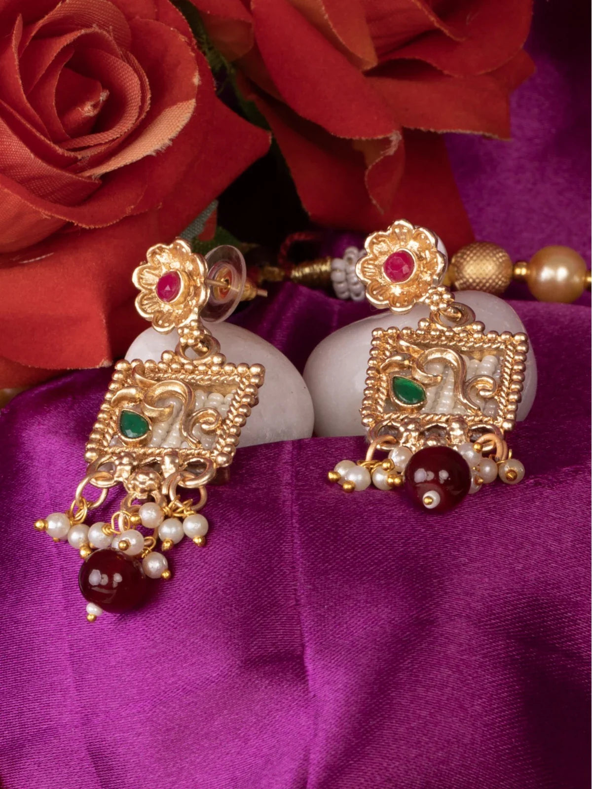 Tarani closeup earrings from gold plated necklace set with pearl and stone detailing