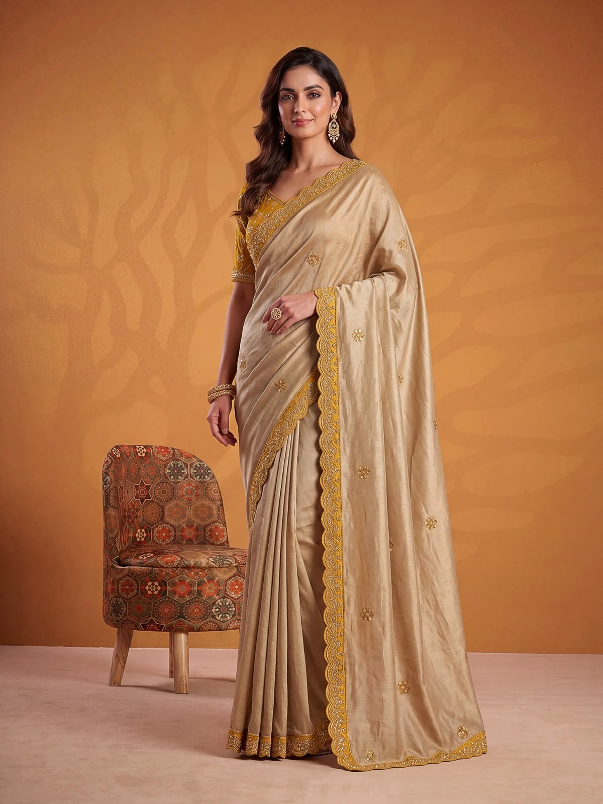Tarani mustard silk saree side view with rich border embroidery and graceful pleated styling