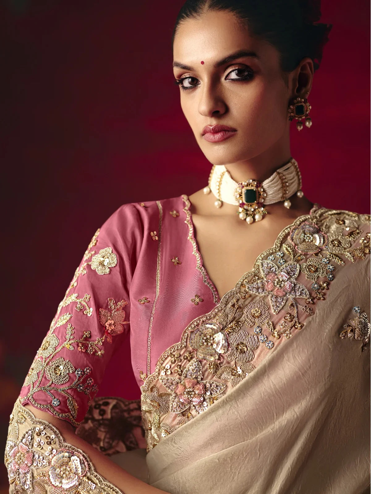 Tarani beige saree with intricate floral work and pink embroidered blouse upper body closeup