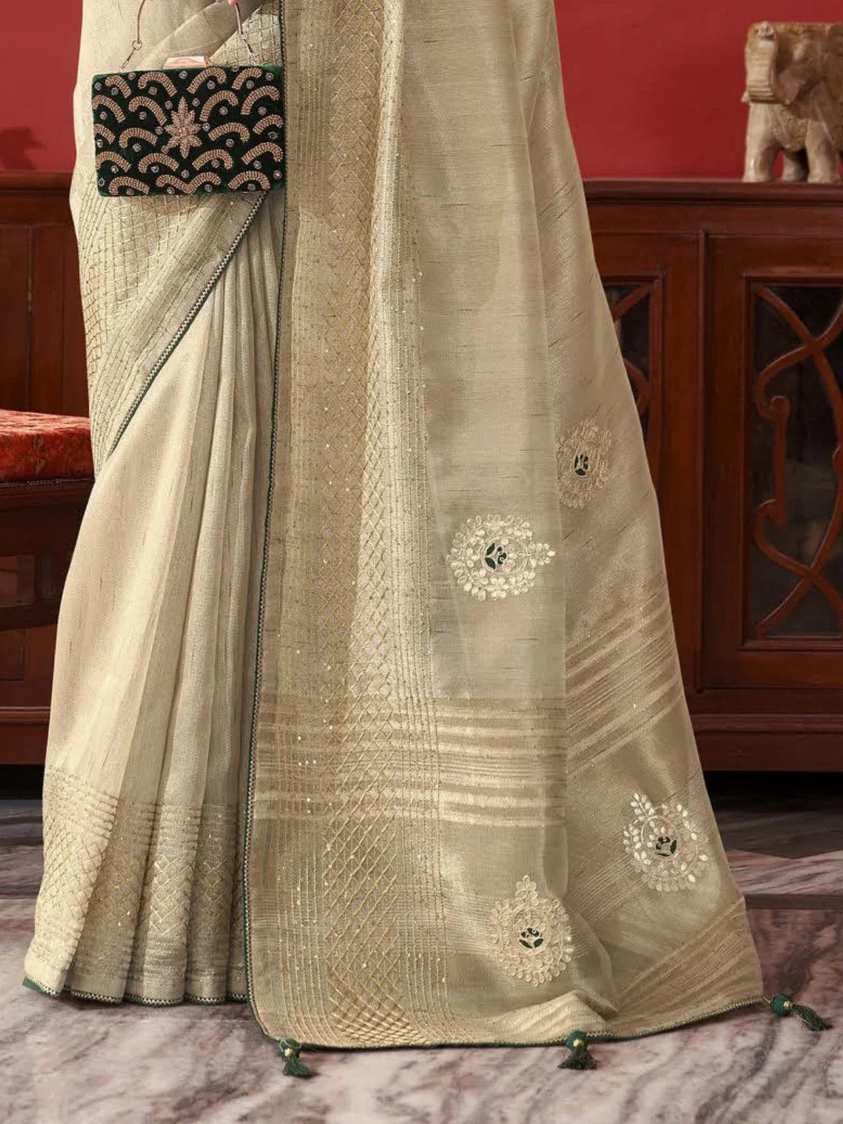 Tarani beige fancy saree front view showing intricate golden border and floral embroidery