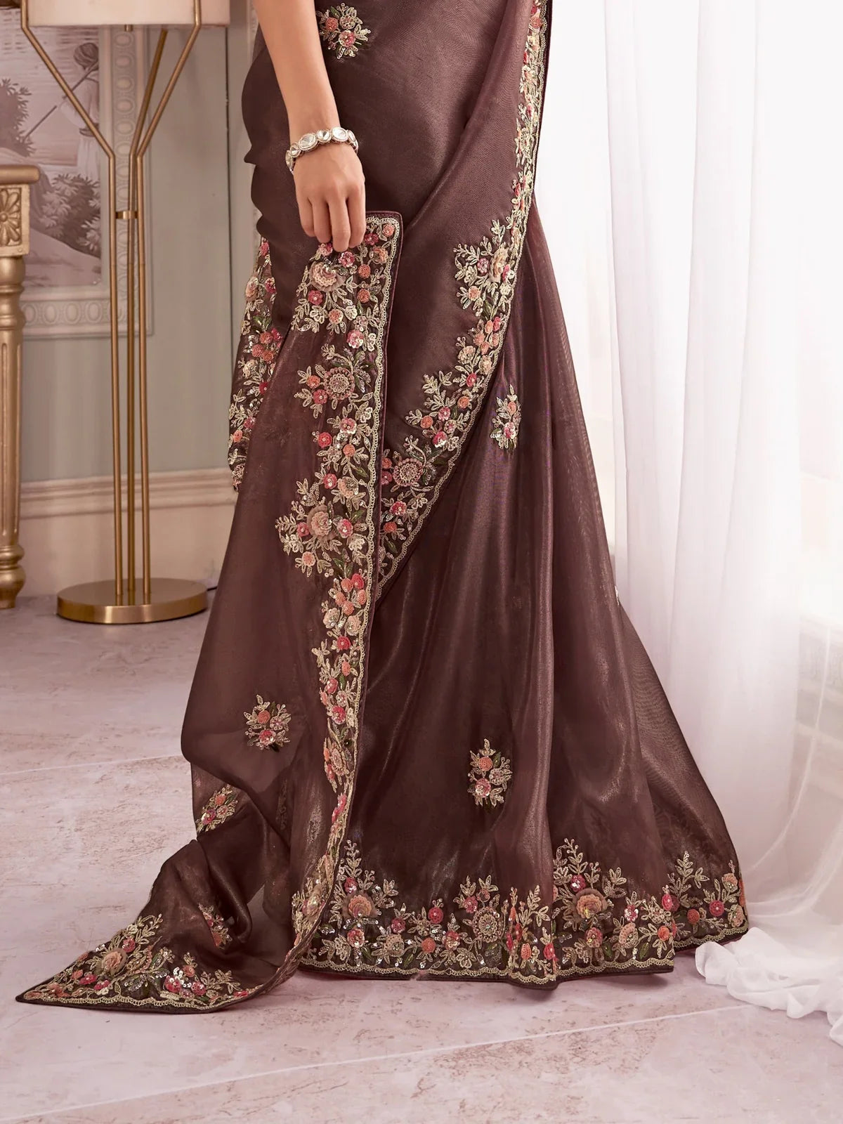 Tarani brown fancy saree pallu view with detailed cutwork and floral embroidery