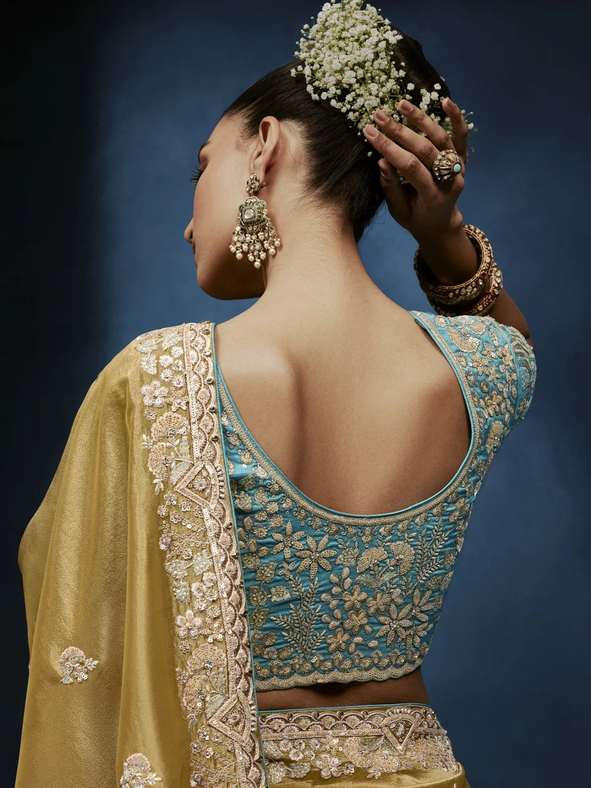 Tarani designer blouse back view with embroidery work paired with golden saree by Tarani