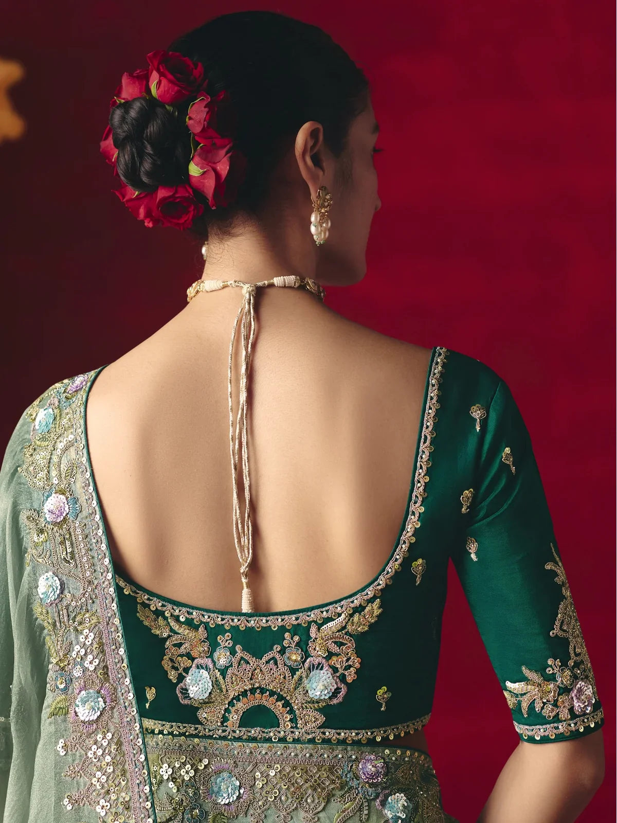 Tarani blouse back view with green embroidery and stone work from festive saree