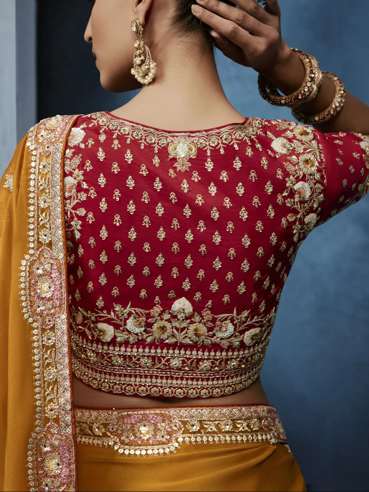 Tarani embroidered maroon blouse back design with mustard saree and festive styling