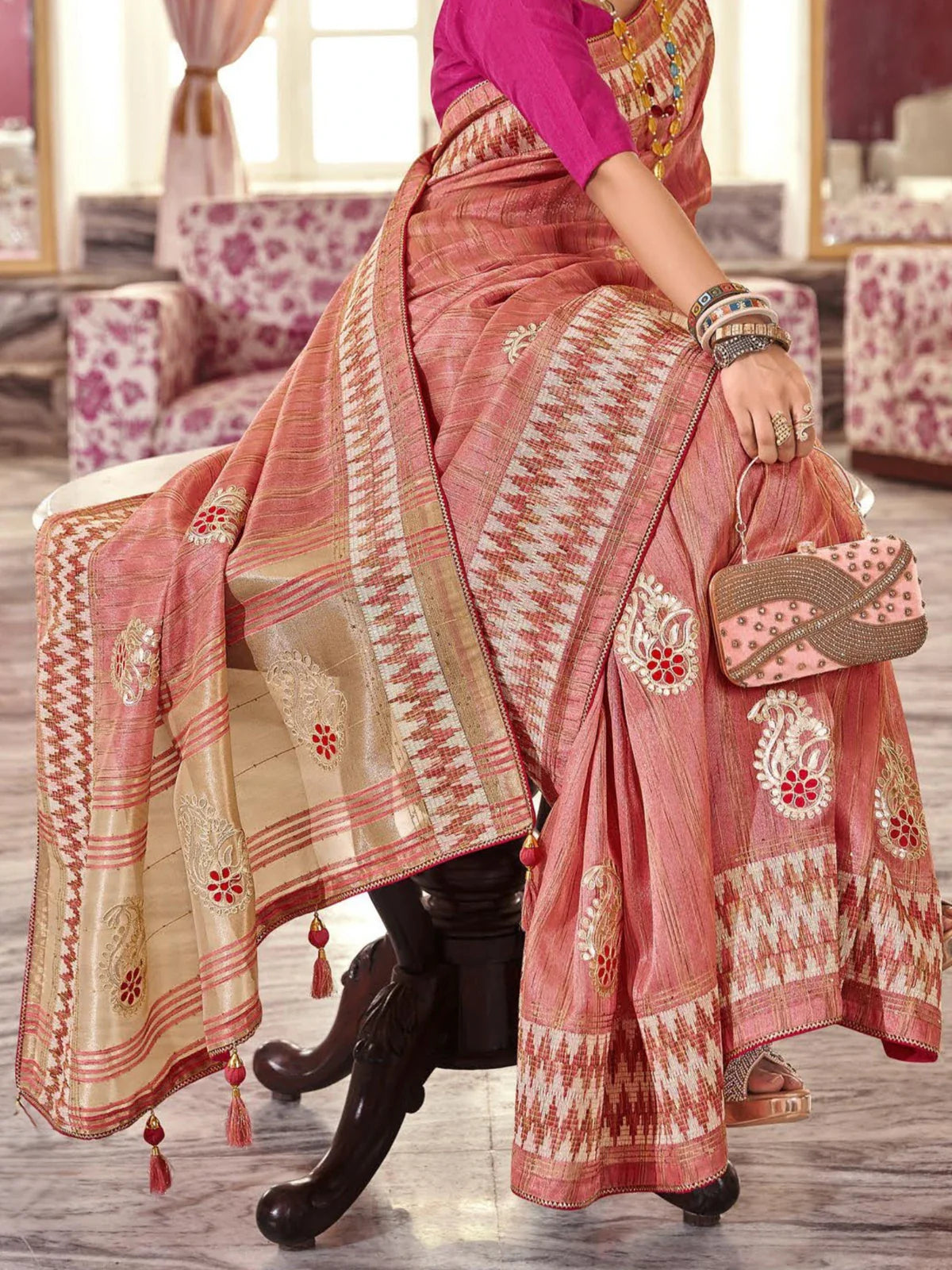 Tarani peach-pink fancy saree pallu view showing zari embroidery and tassel detailing