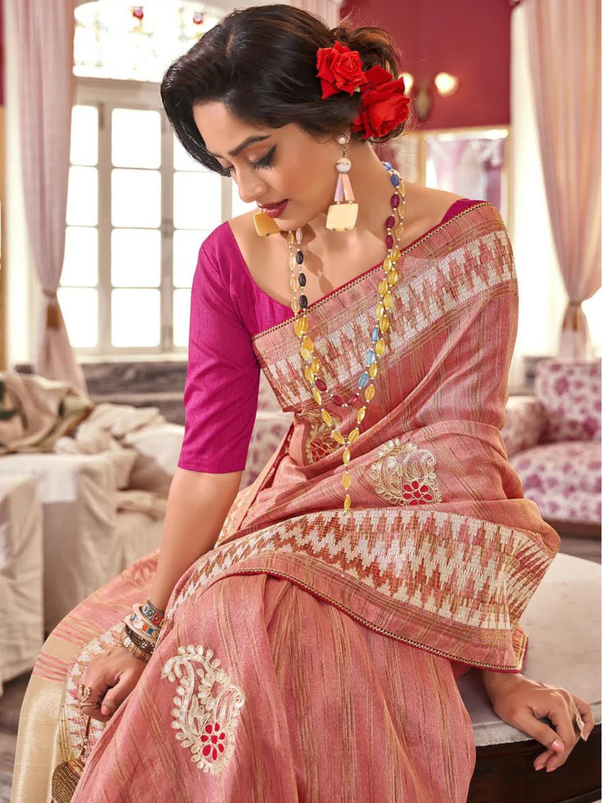 Tarani peach-pink fancy saree upper body view with elegant blouse and jewelry