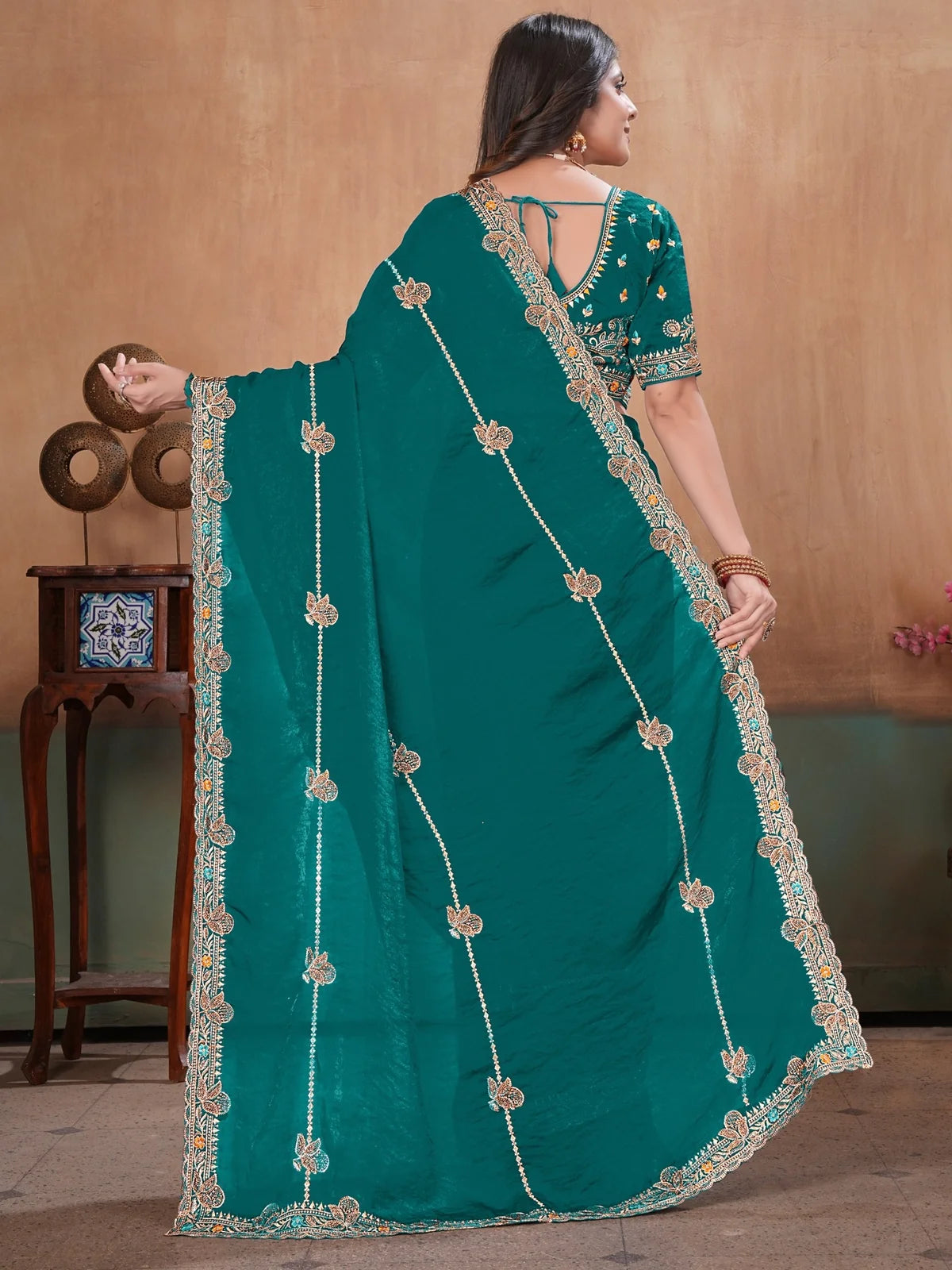 Tarani teal Fandy Satin saree back view displaying embroidered border and pallu