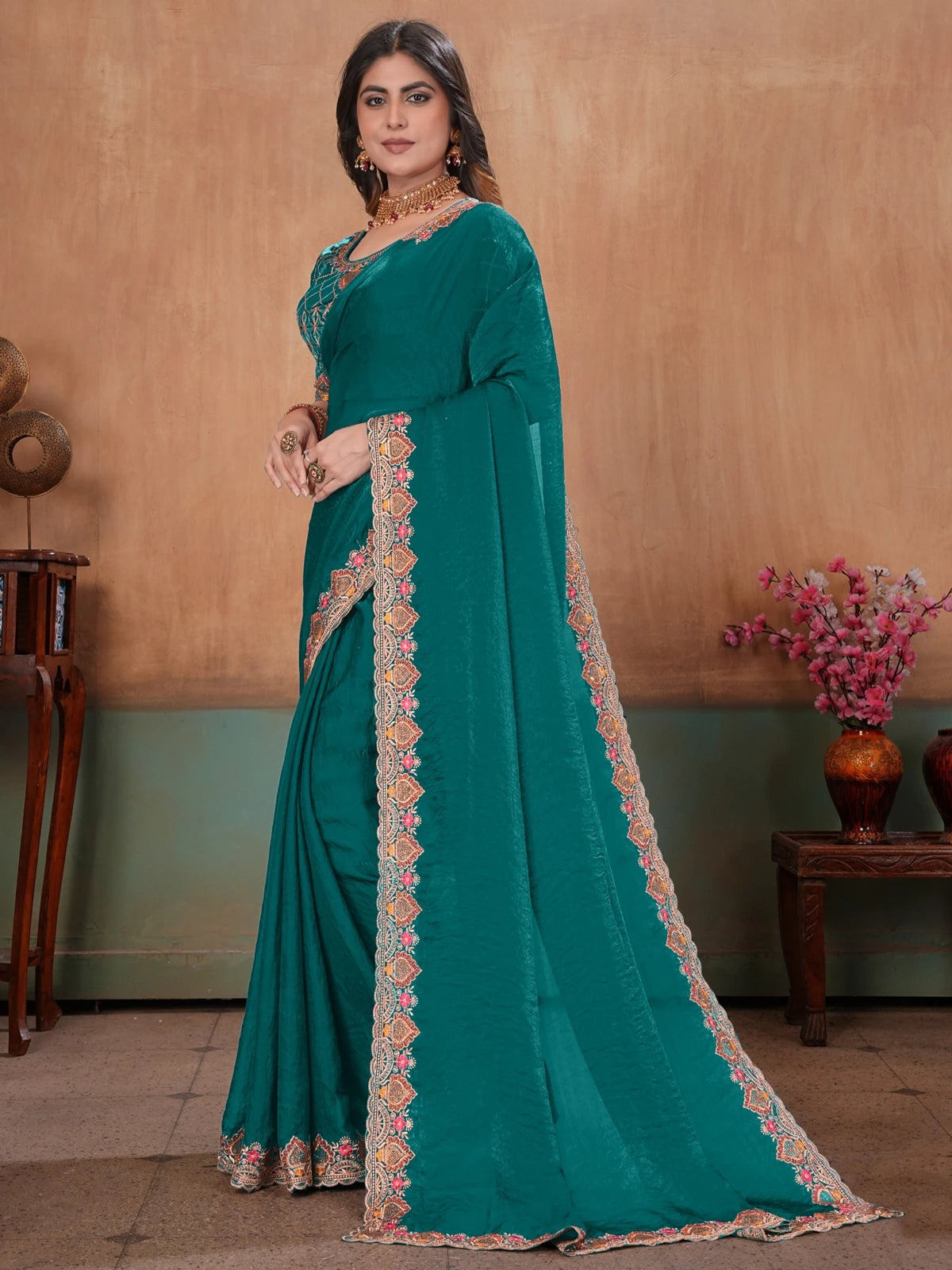 Tarani side view of teal Soft Fandy Satin embroidered saree