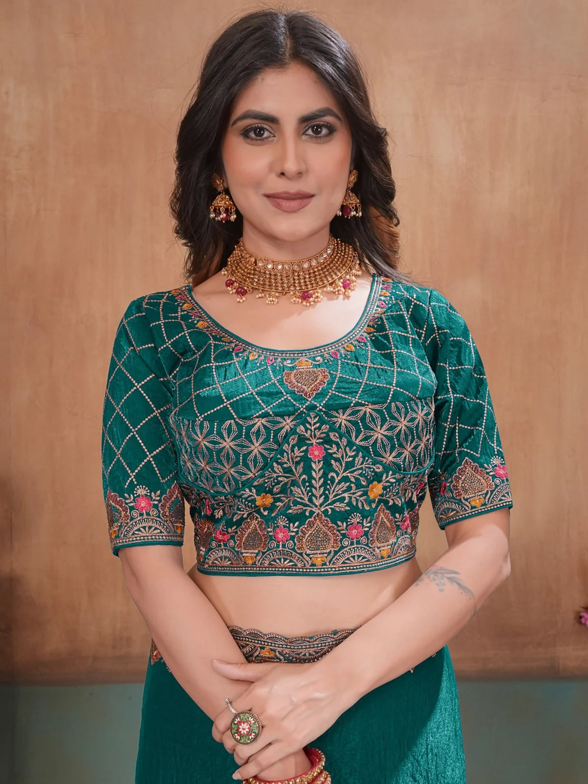 Tarani upper body view of teal embroidered blouse with Soft Fandy Satin saree