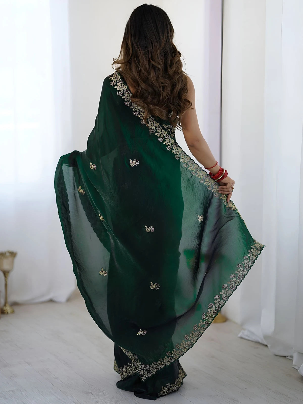 Tarani green Fandy Satin Silk saree back view with embroidered pallu and flowing drape