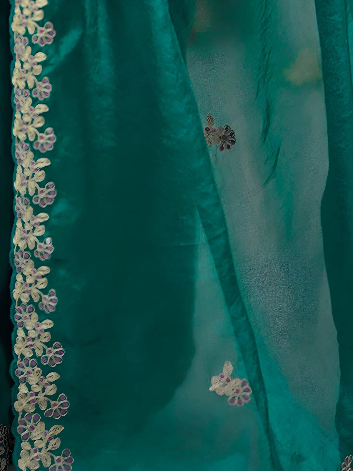 Tarani Aabha green saree closeup of sequin thread embroidery and cutwork floral border