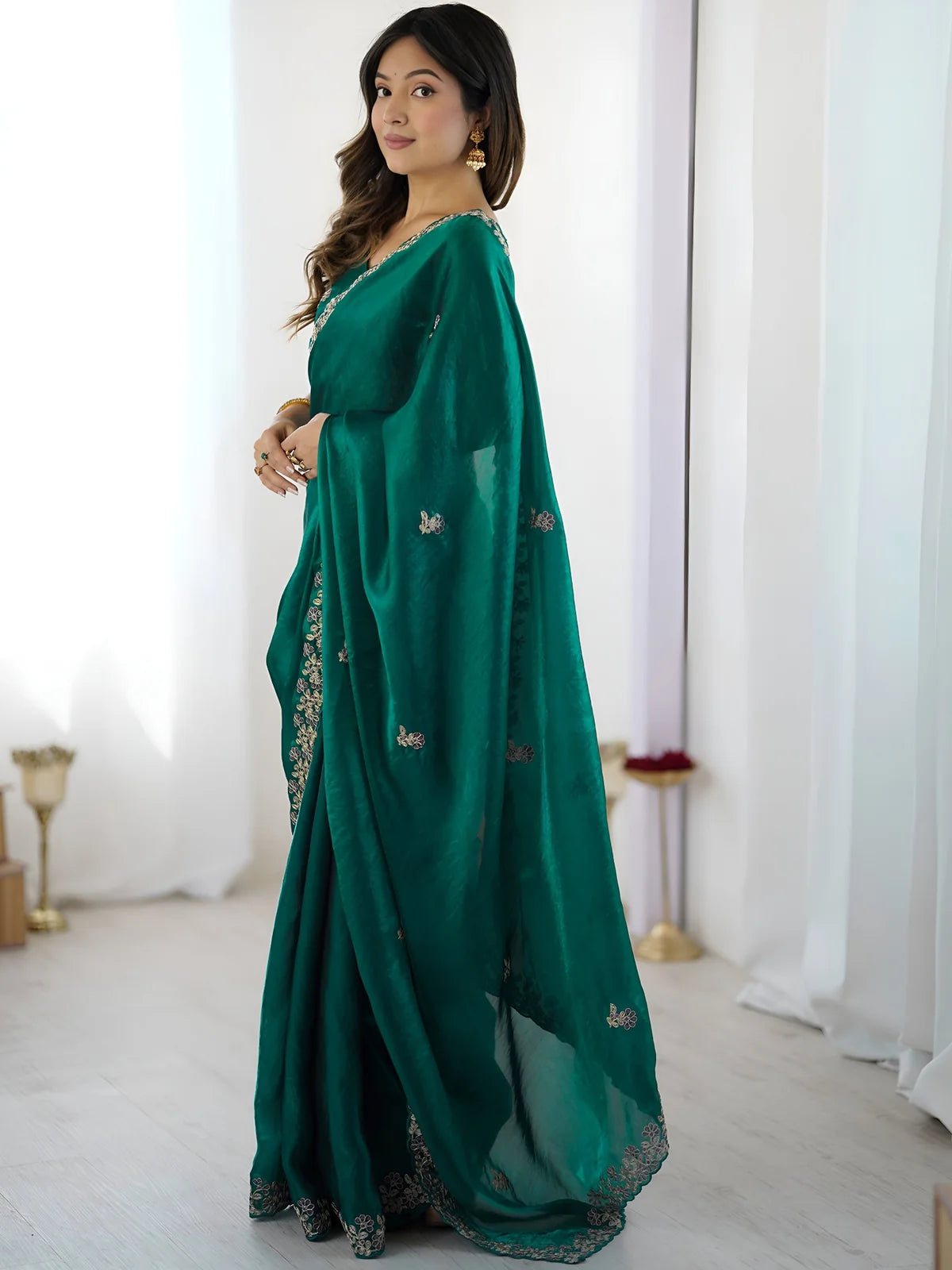 Tarani Aabha green embroidered saree side view with flowing pallu and elegant drape
