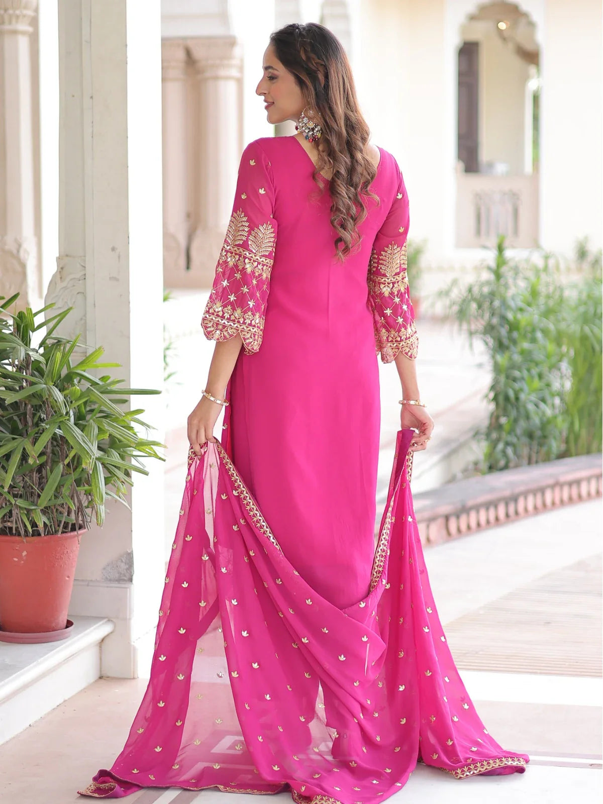 Back view of Tarani faux blooming dress in bright pink with embroidery