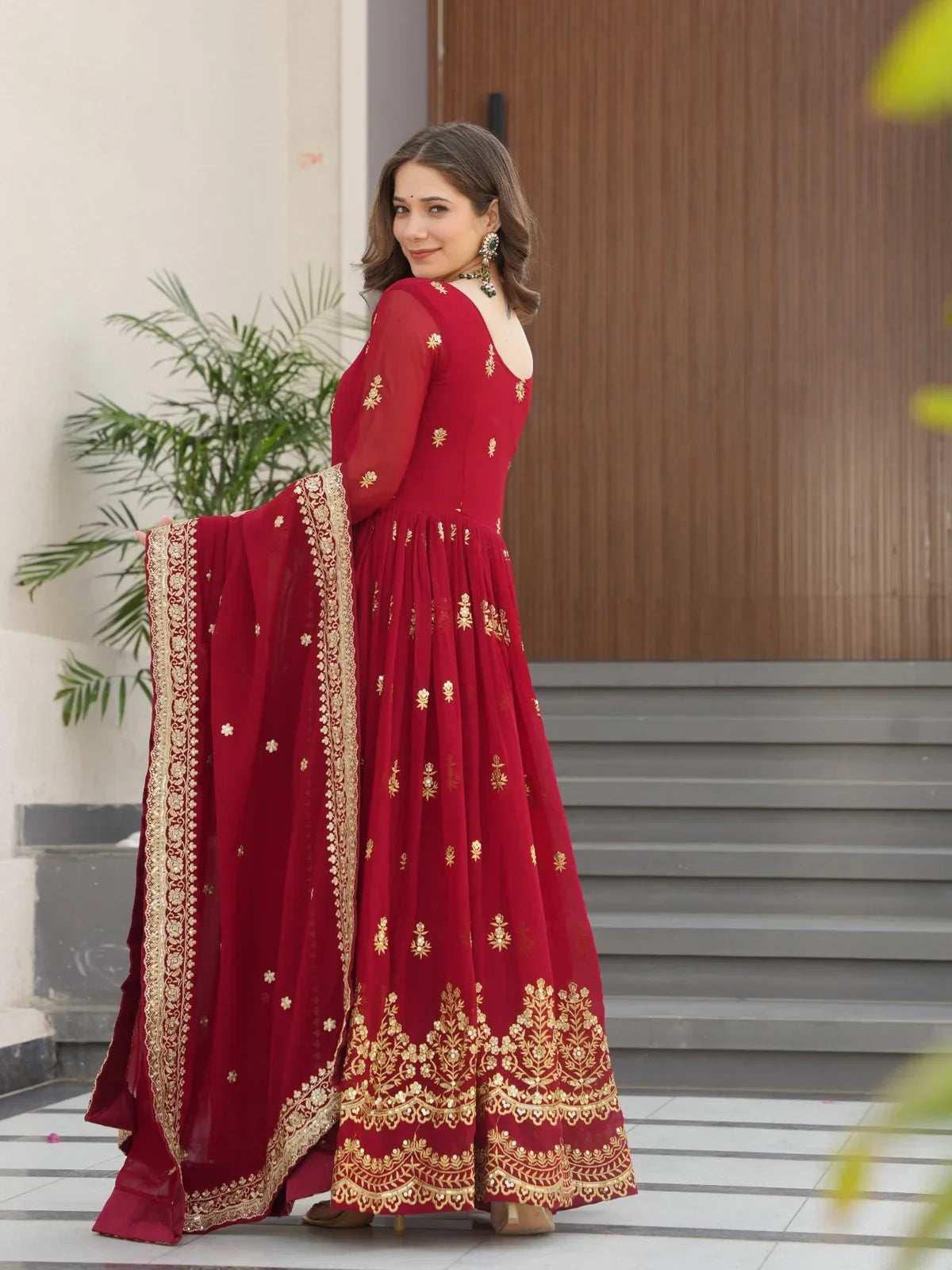 Tarani maroon gown with full sleeves and golden detailing seen from elegant back and side angle