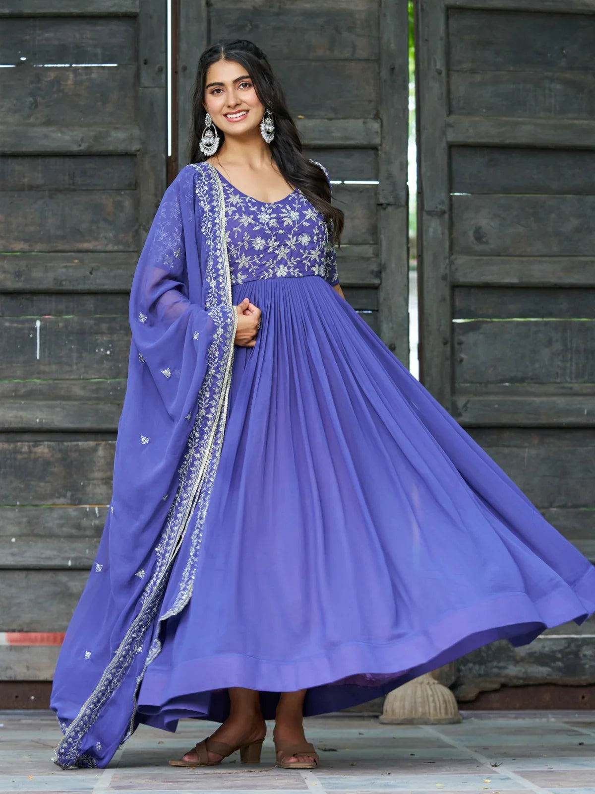 Tarani purple faux blooming gown front view with flared twirl pose highlighting fabric flow and design