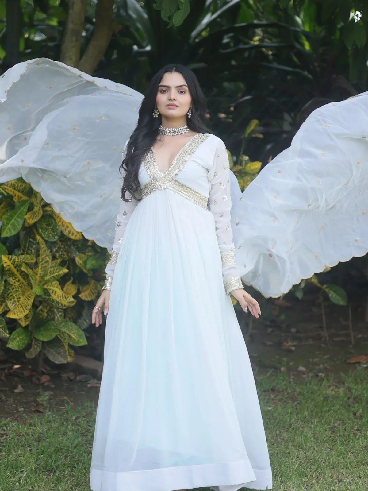 Tarani front pose of white faux blooming party gown with dupatta spread like wings