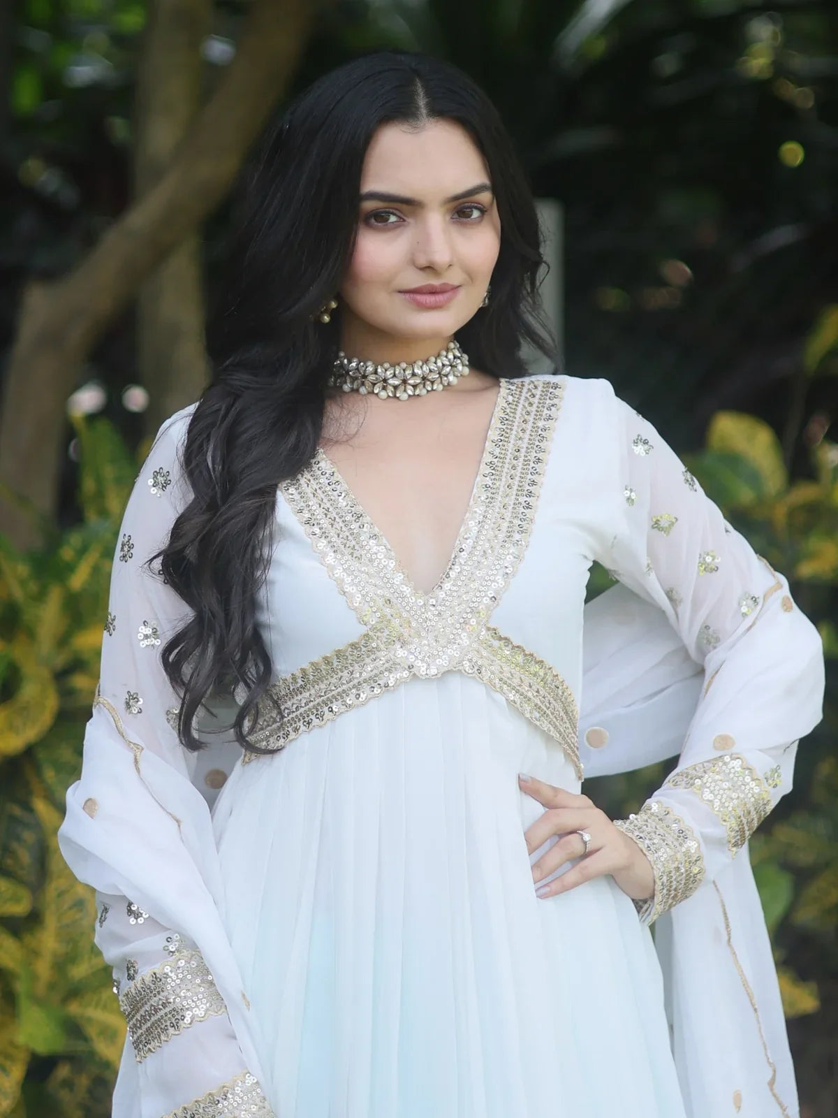 Tarani close up of white faux blooming gown showing embroidery on neckline and sleeves