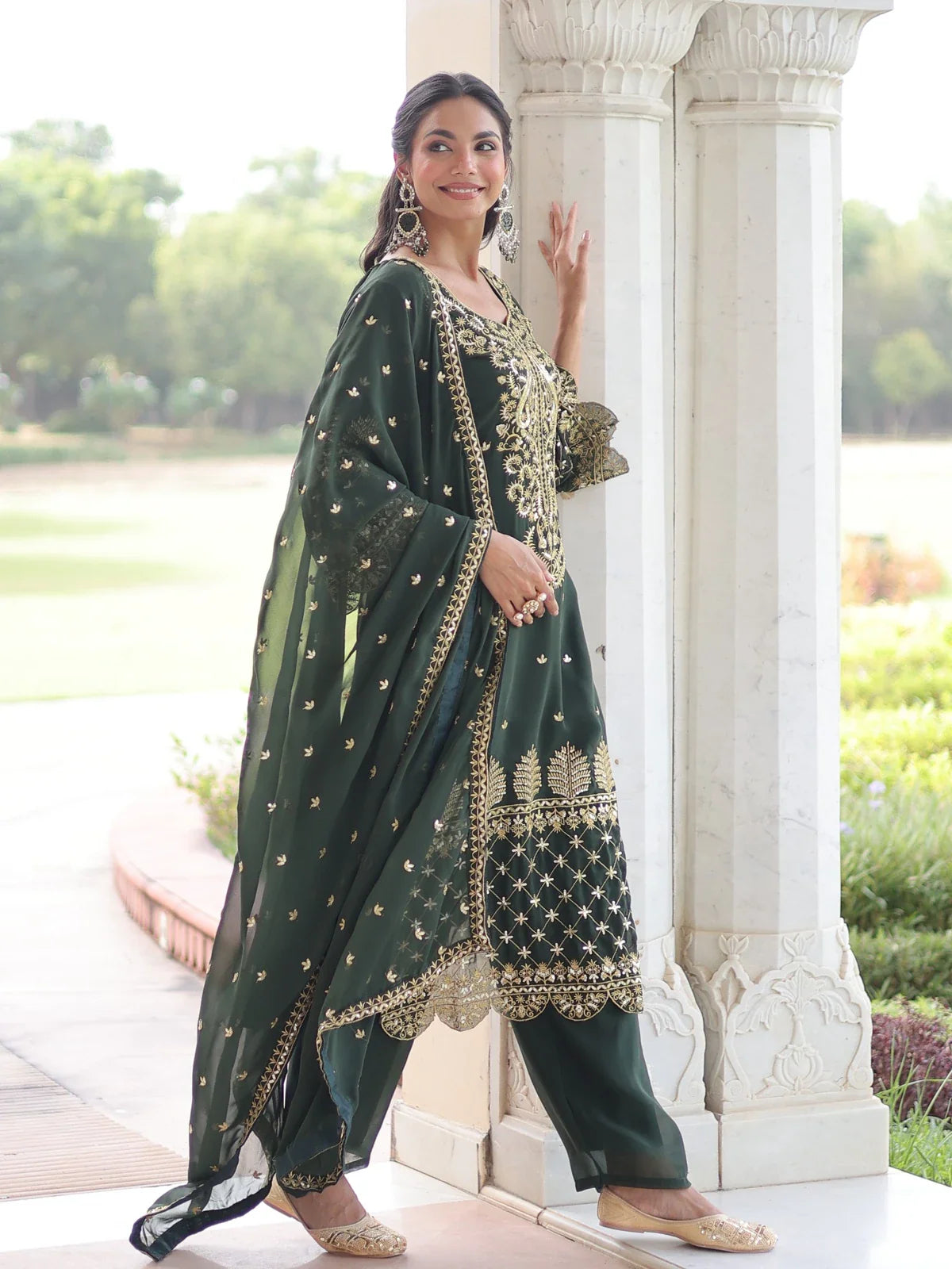 Tarani designer green faux blooming dress side view with gold embroidery and dupatta flow