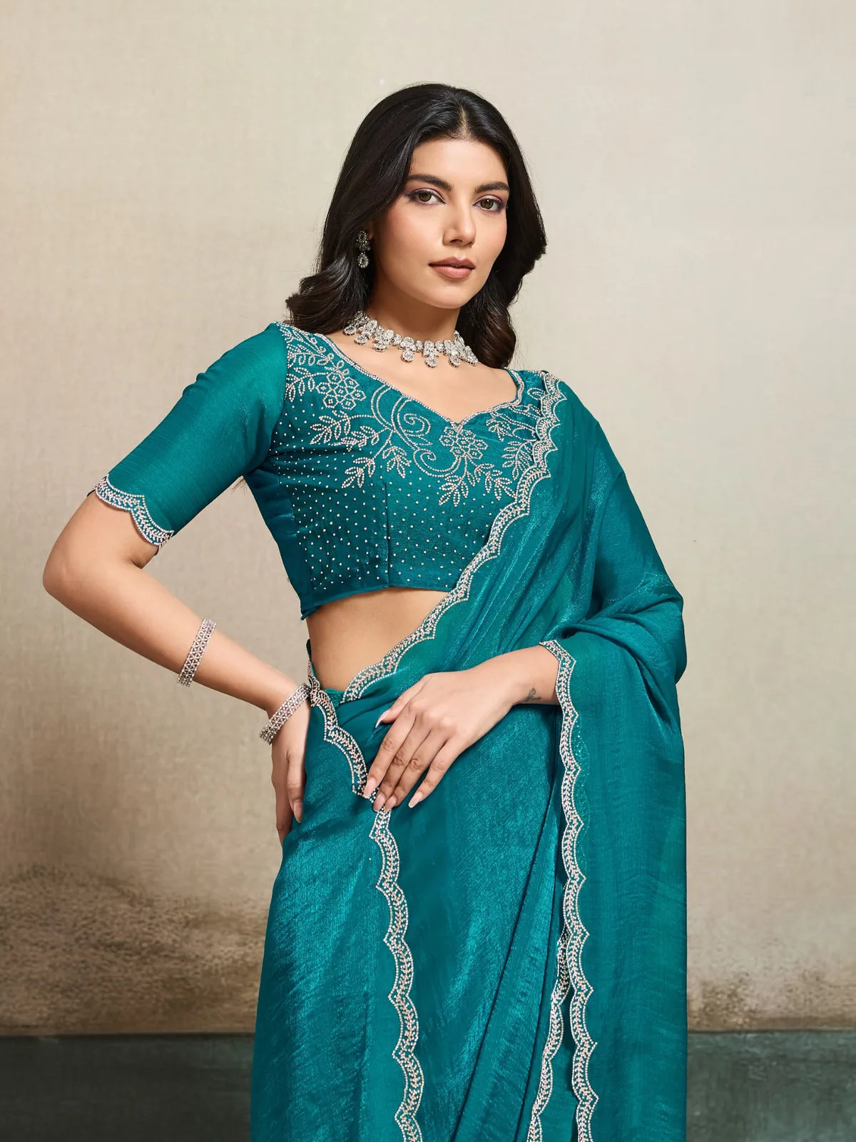 Tarani teal wedding wear saree highlighting pallu border and elegant drape