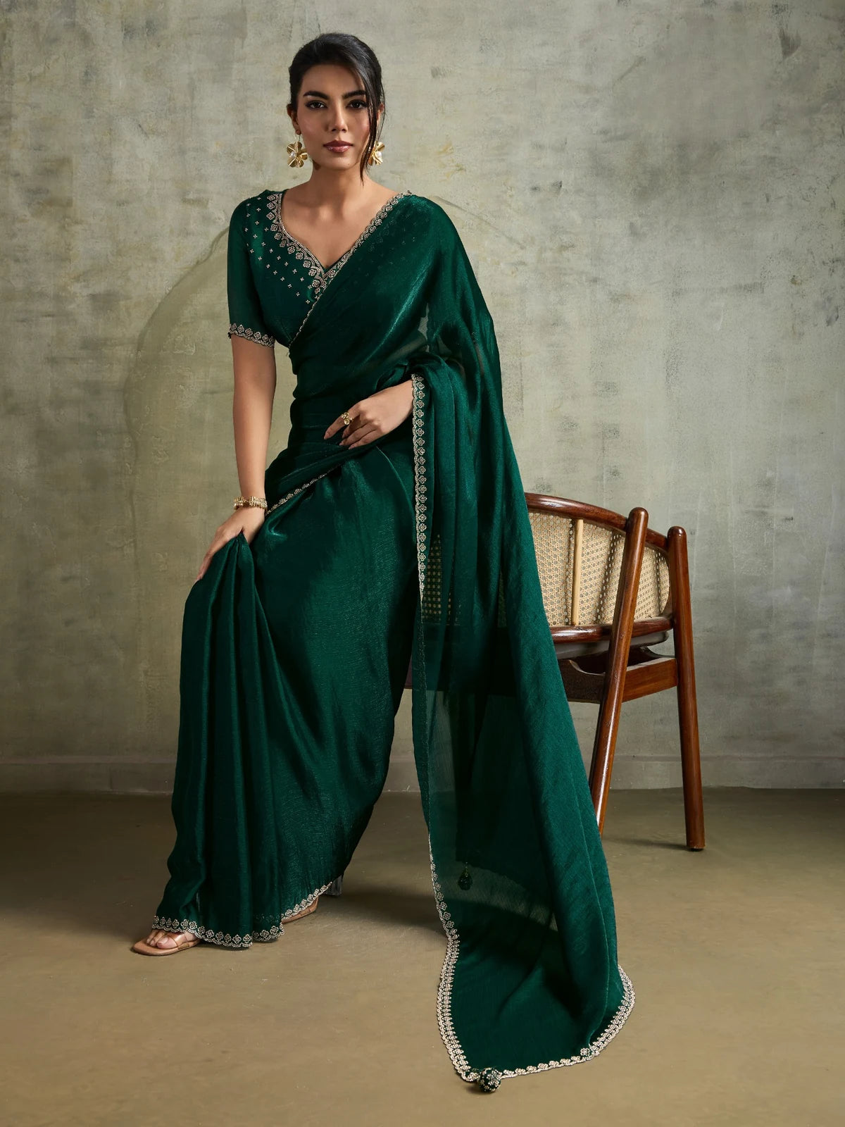 Tarani green party wear saree with designer blouse and detailed drape front seated view