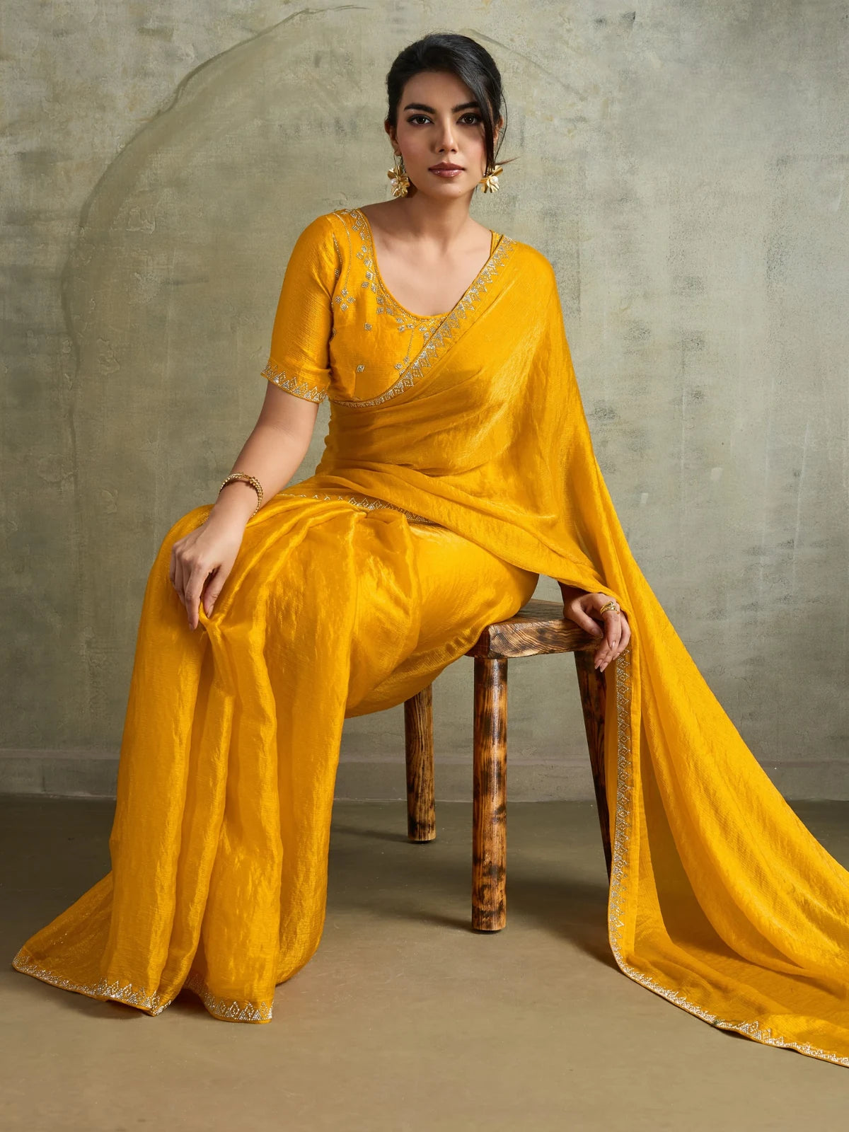Tarani yellow party wear saree front view with embroidered blouse and flowing pallu