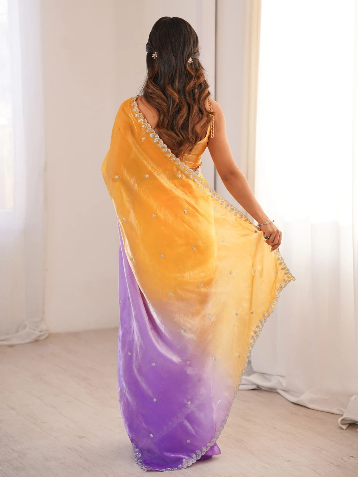 Tarani Divyashri yellow Fendy Satin saree back view displaying ombre drape and border