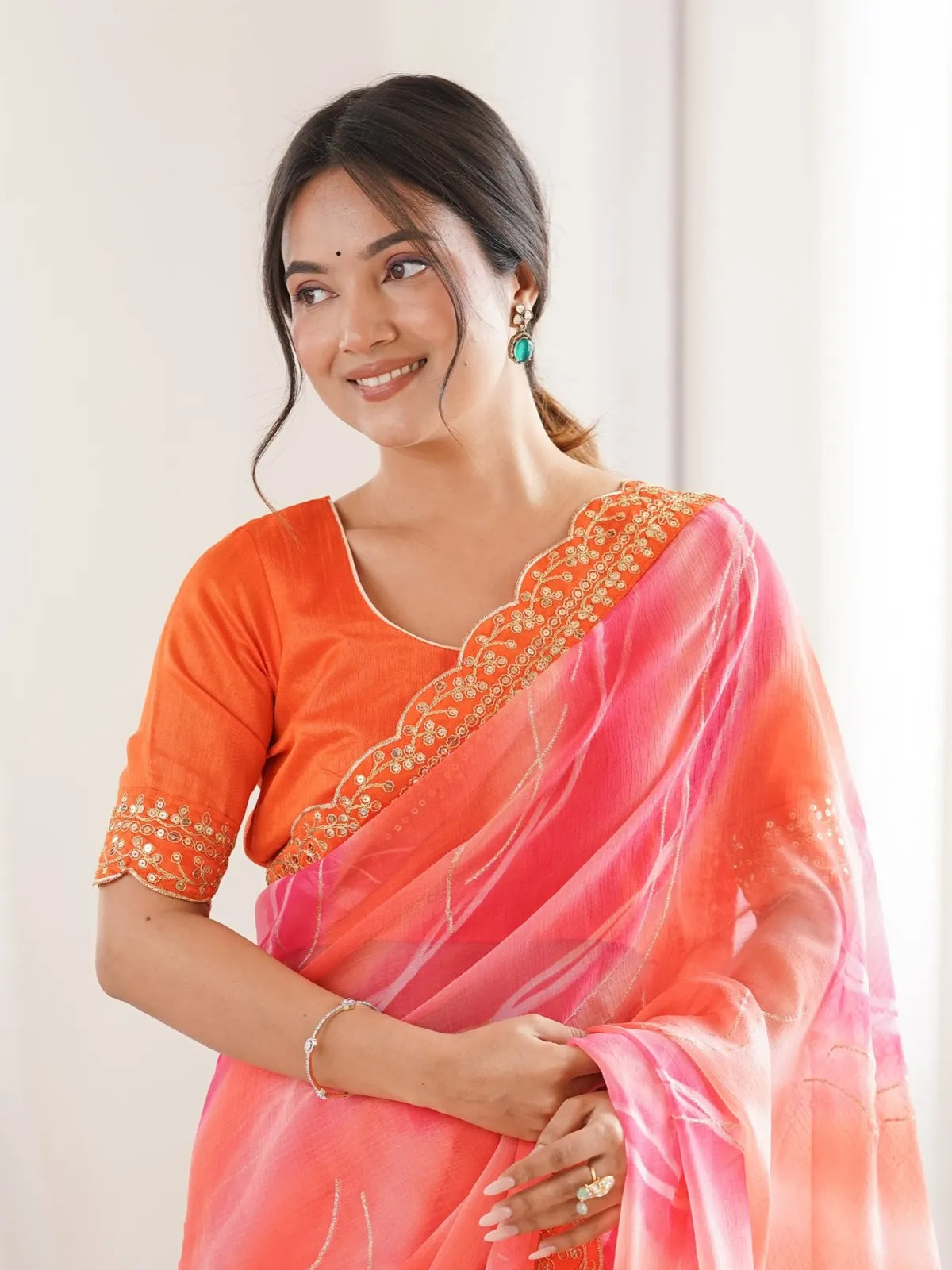 Tarani orange saree upper body view with elegant blouse detailing and festive design