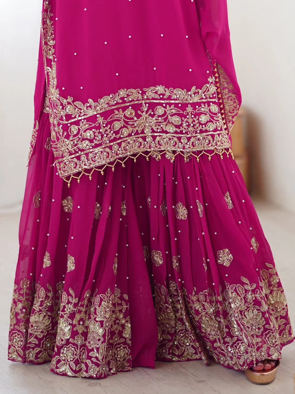 Tarani closeup of magenta georgette sharara with golden embroidery