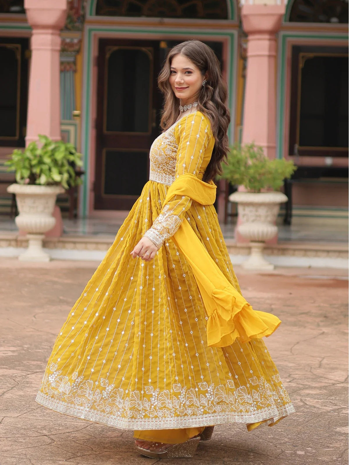 Tarani yellow georgette festive dress side view highlighting flare and embroidery work