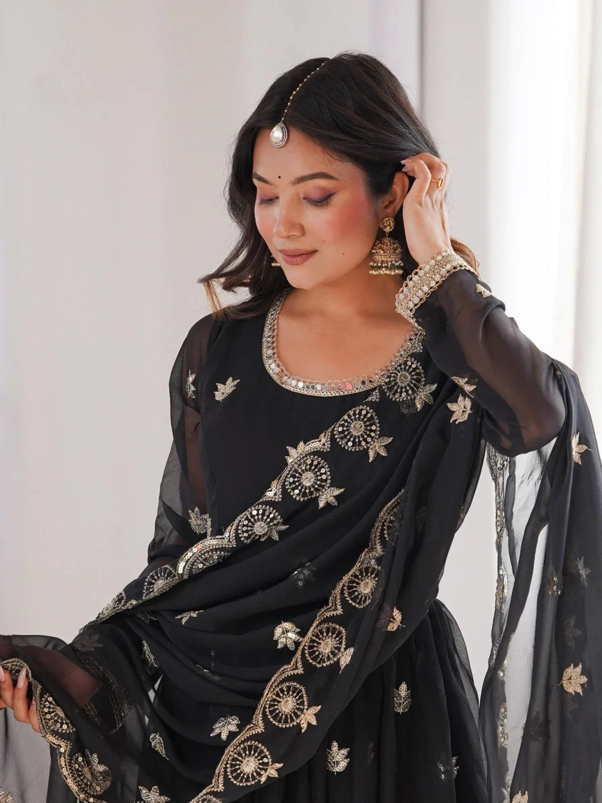 Tarani premium georgette gown in black showing neckline and sleeve embroidery