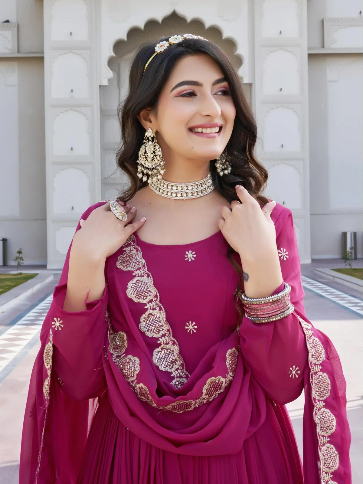 Tarani magenta georgette gown upper body view showing round neck and embroidery