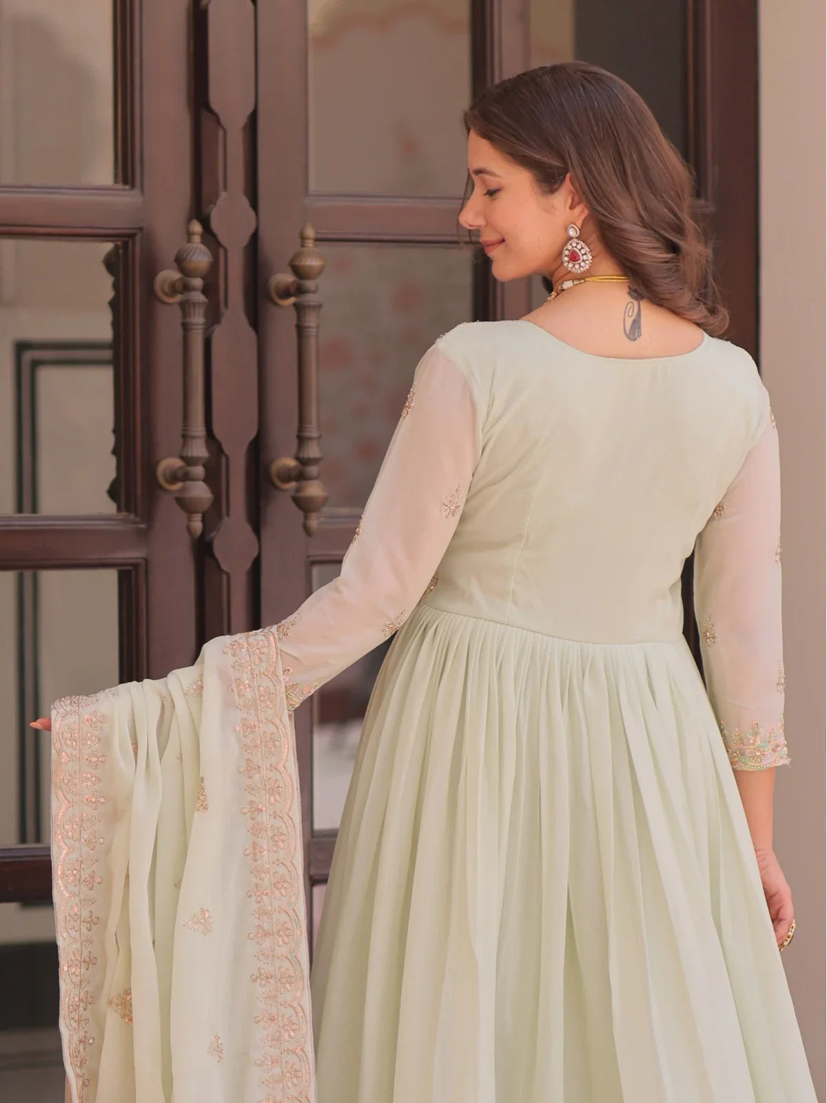Tarani mint green georgette embroidered gown back design view